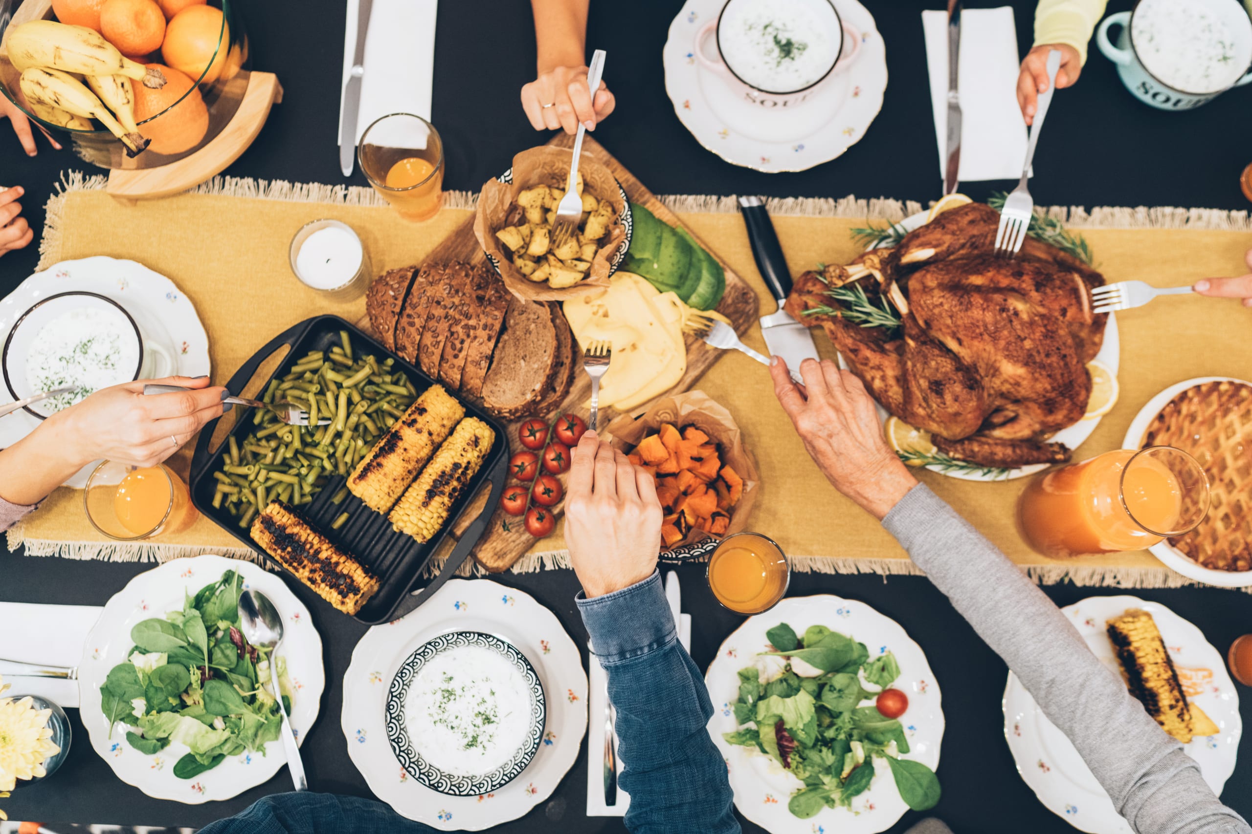 Overhead view of big family eating from table during Christmas dinner