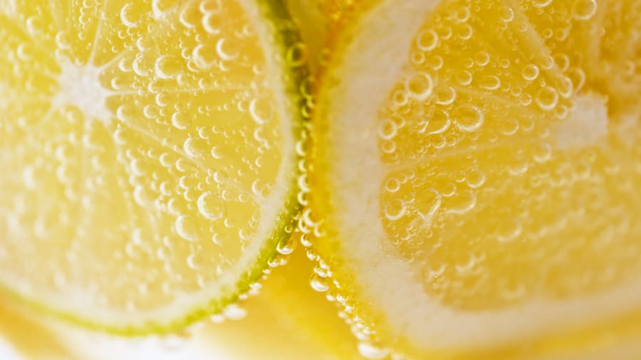 Close-up of carbonated water with slices of lemon and lime.