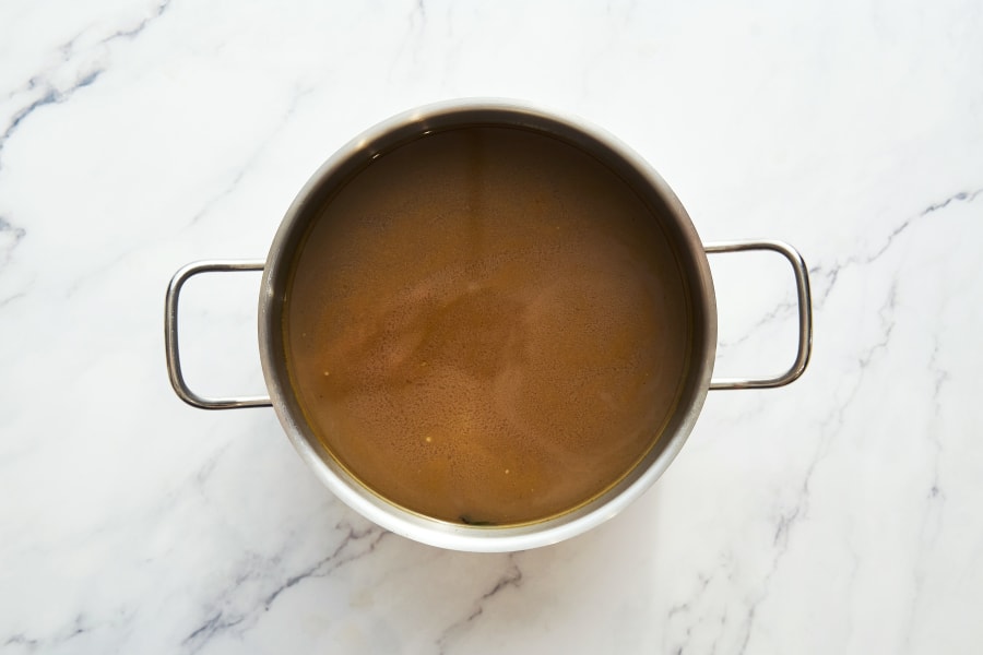 Vegetable stock in the pot on white background. Top view High quality photo