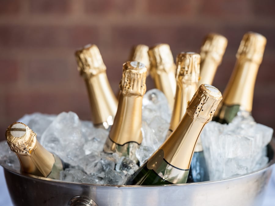 Champagne bottle in a bucket of ice.