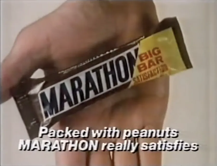 Hand holding Marathon candy bar, from 1986 commercial, posted to YouTube by CR's Video Vaults