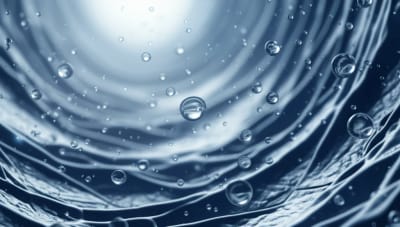 Microscopic droplets floating in a clear fluid within a network of microchannels