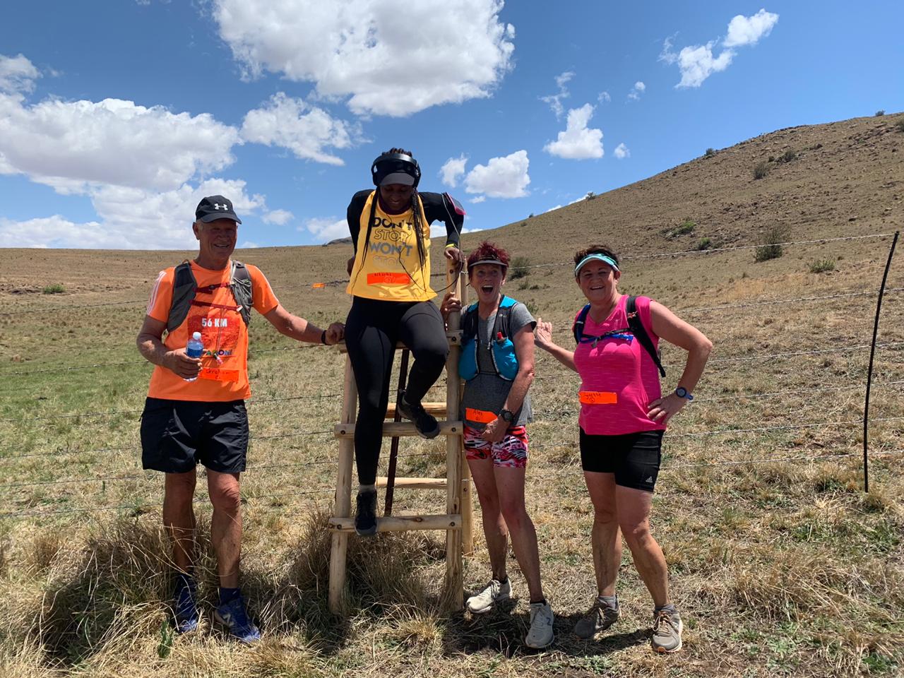 a group of four runners on a hillside