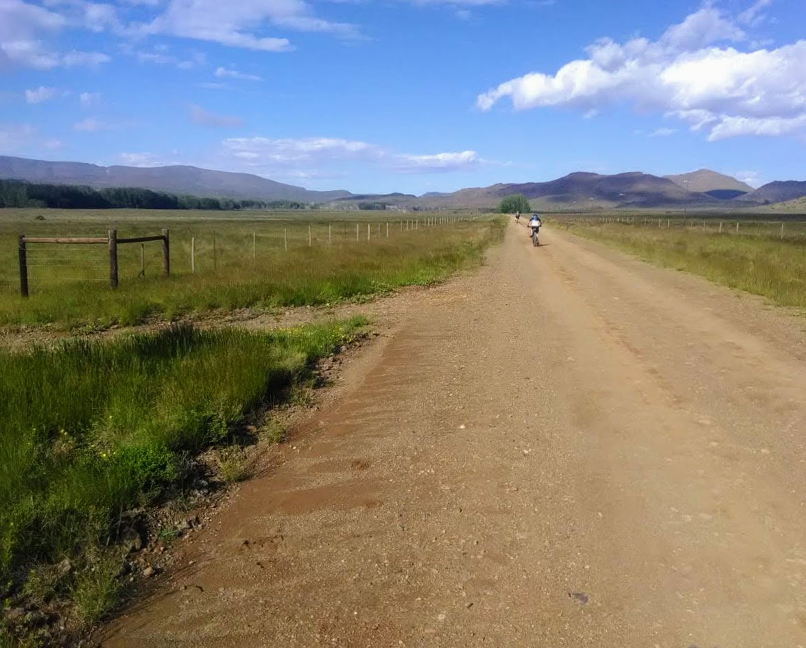 cycling down a picturesque dirt road in the karoo