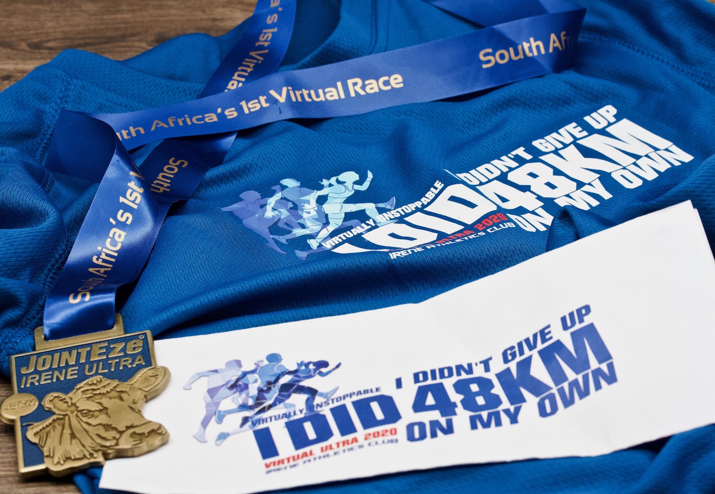 a running shirt and medal from the Irene running club virtual 48km race