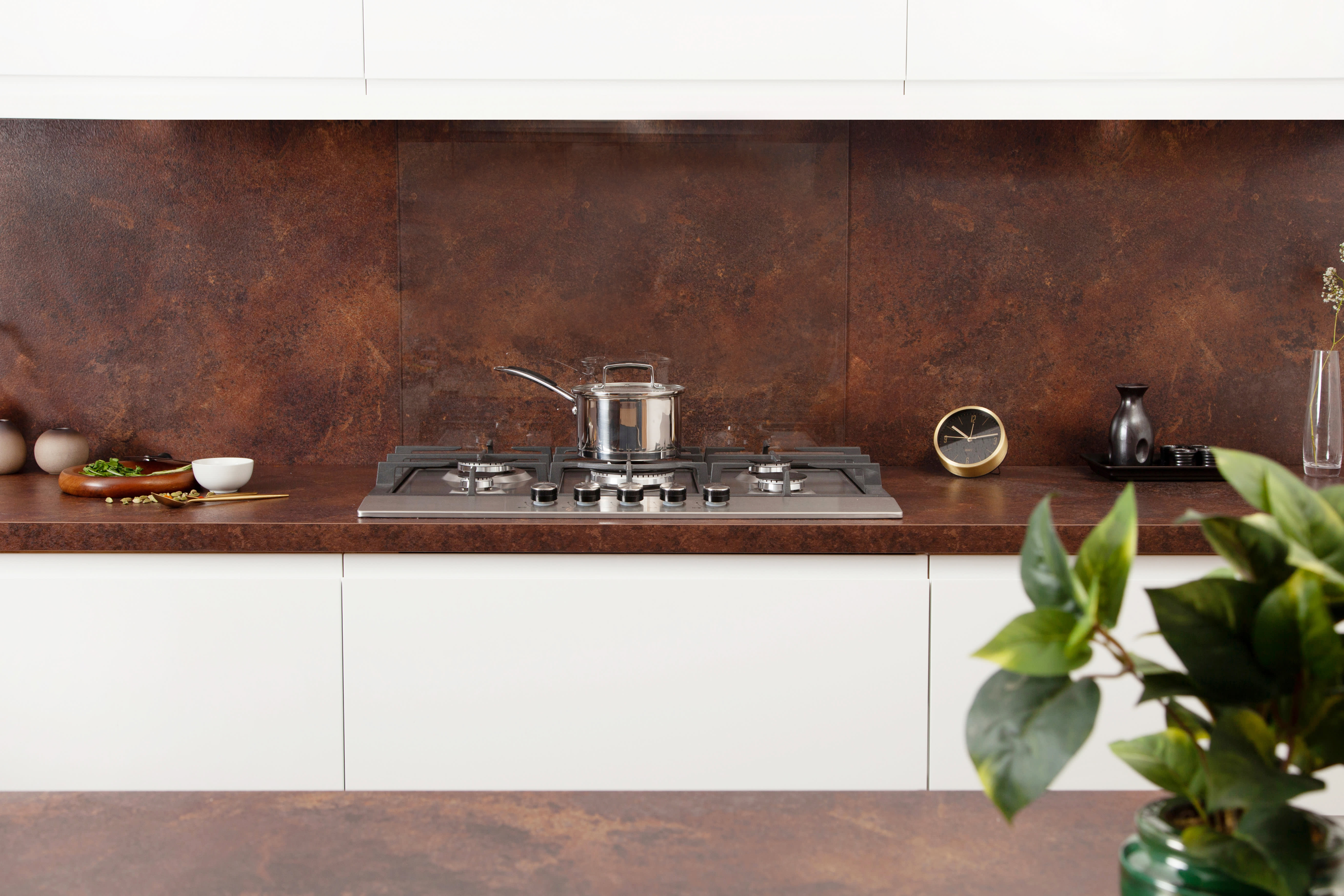 Copper Effect Worktop In Kitchen With Hob, Spices and Plant