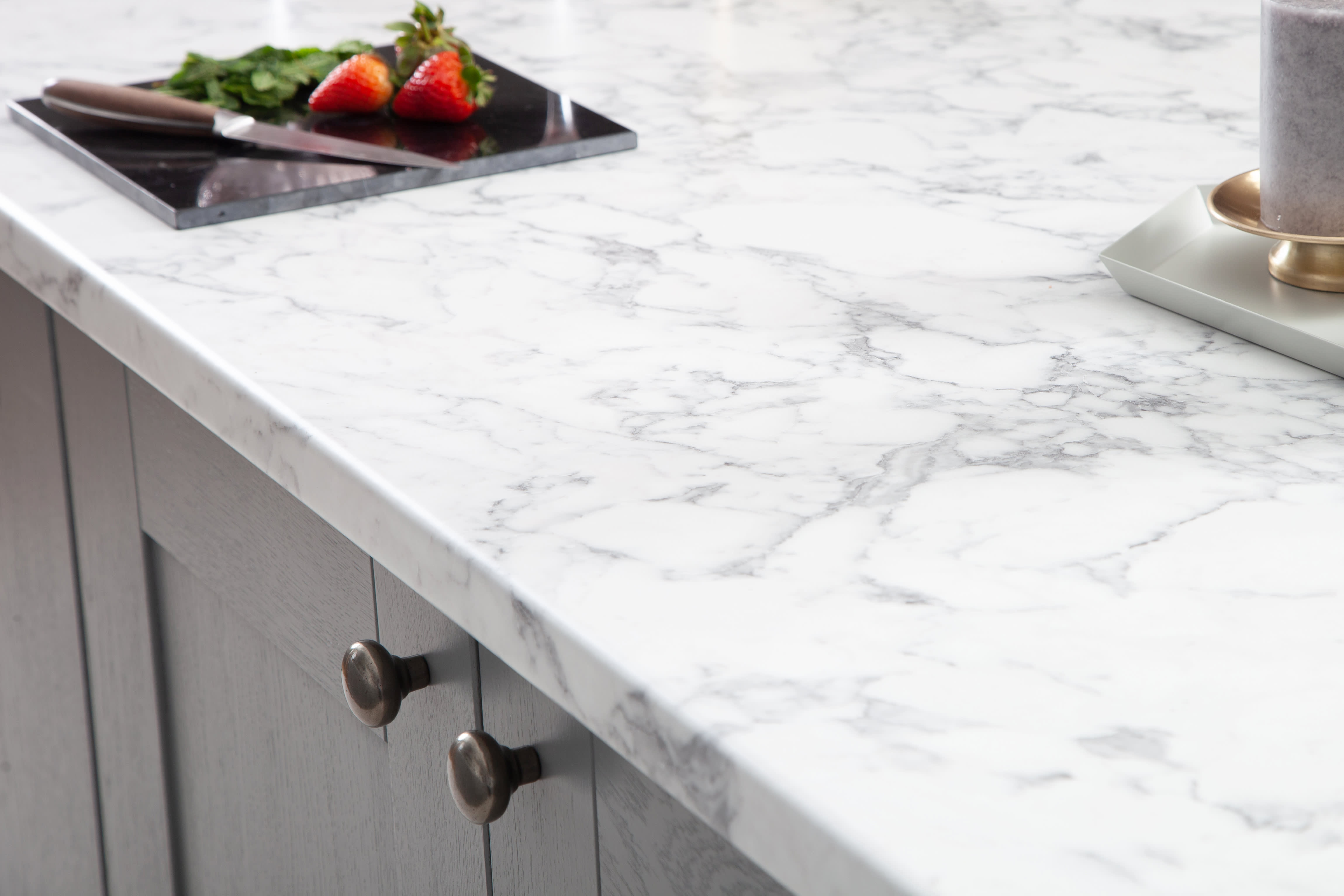 Marble Calcutta Laminate Worktop with strawberries on black glass chopping board