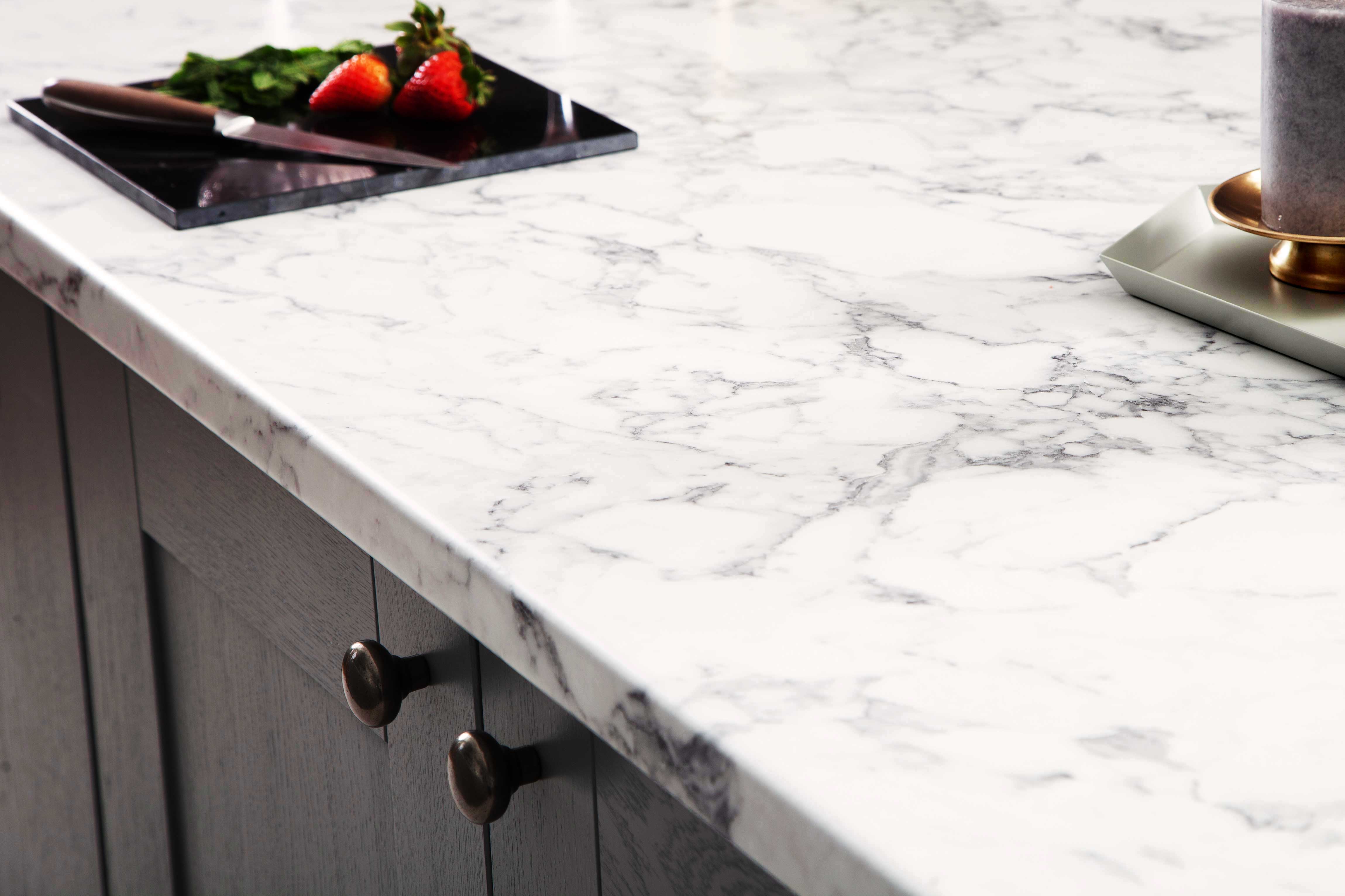 Marble Calcutta Laminate Worktop with strawberries on black glass chopping board