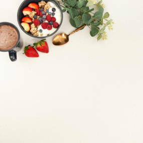 Arctic Solid Surface With coffee and bowl of granola with fresh berries on worktop