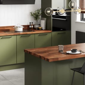 Walnut solid wooden worktops in green kitchen with breakfast bar