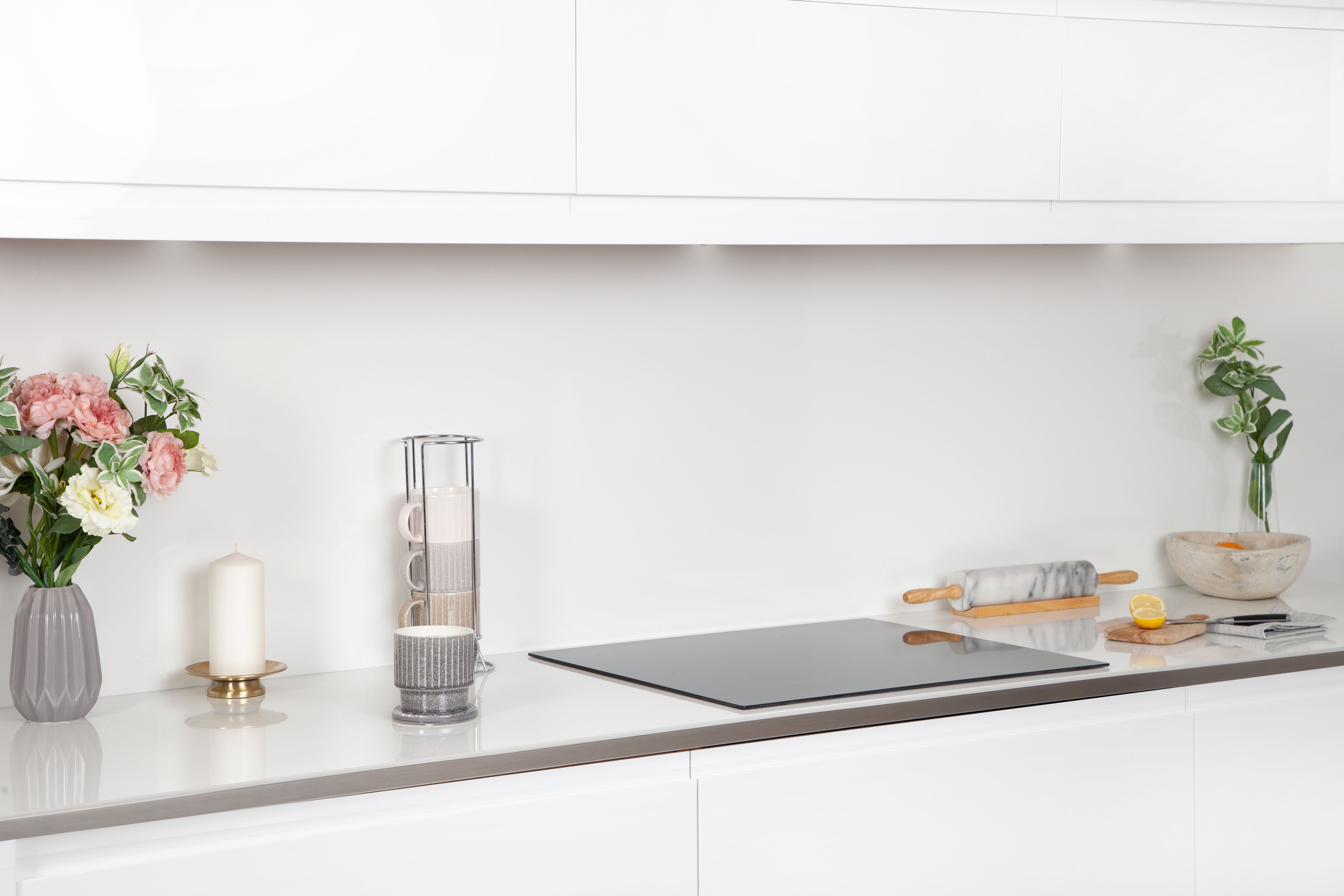 White Glass Kitchen Worktop with coffee, hob, baking and flowers