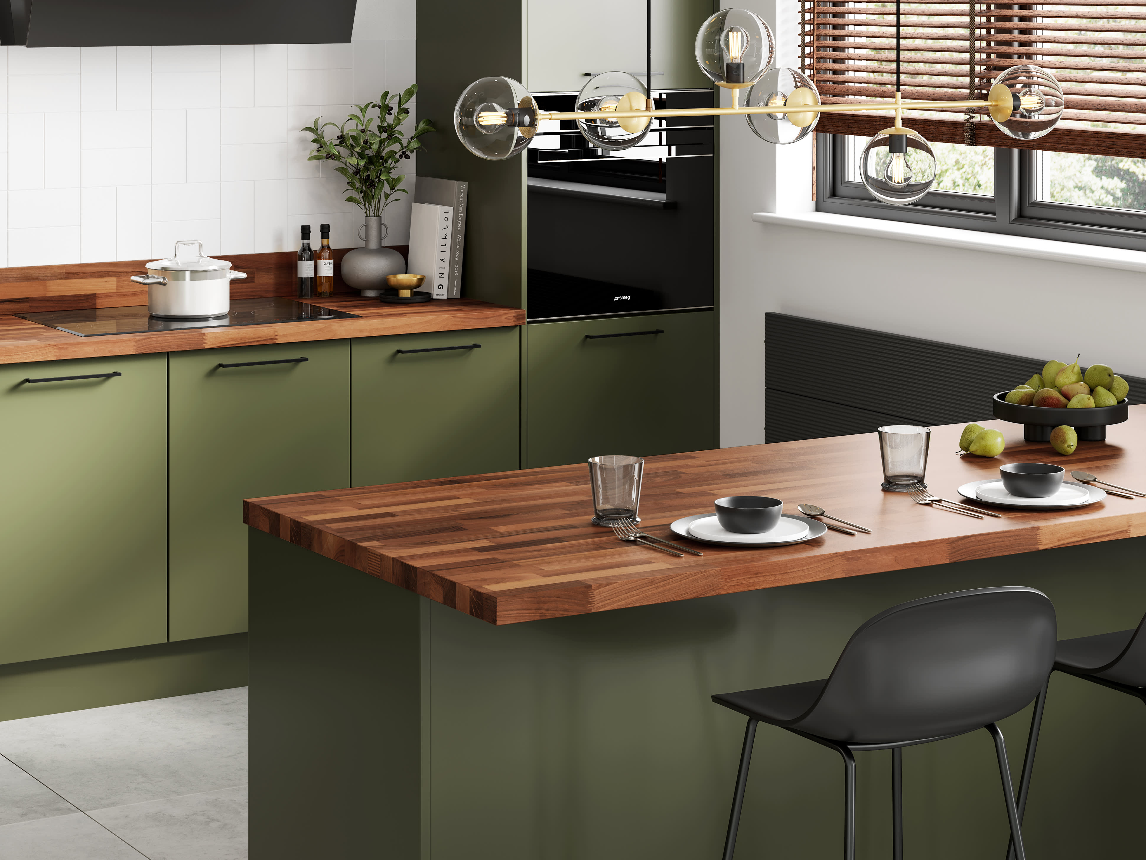 Walnut solid wooden worktops in green kitchen with breakfast bar