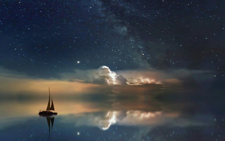 Sailboat sailing towards the starry horizon.