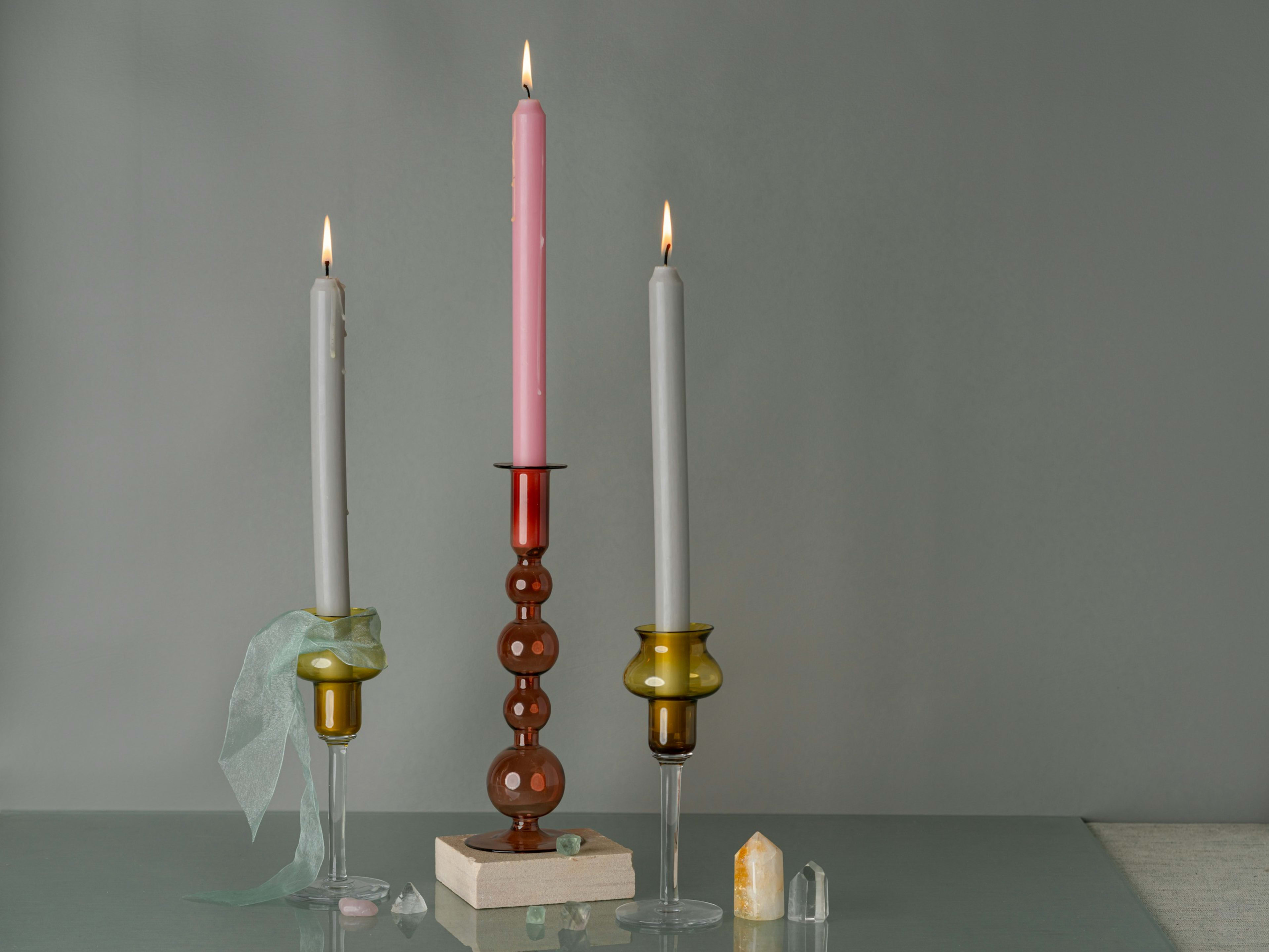 Glass candleholders in rose and amber