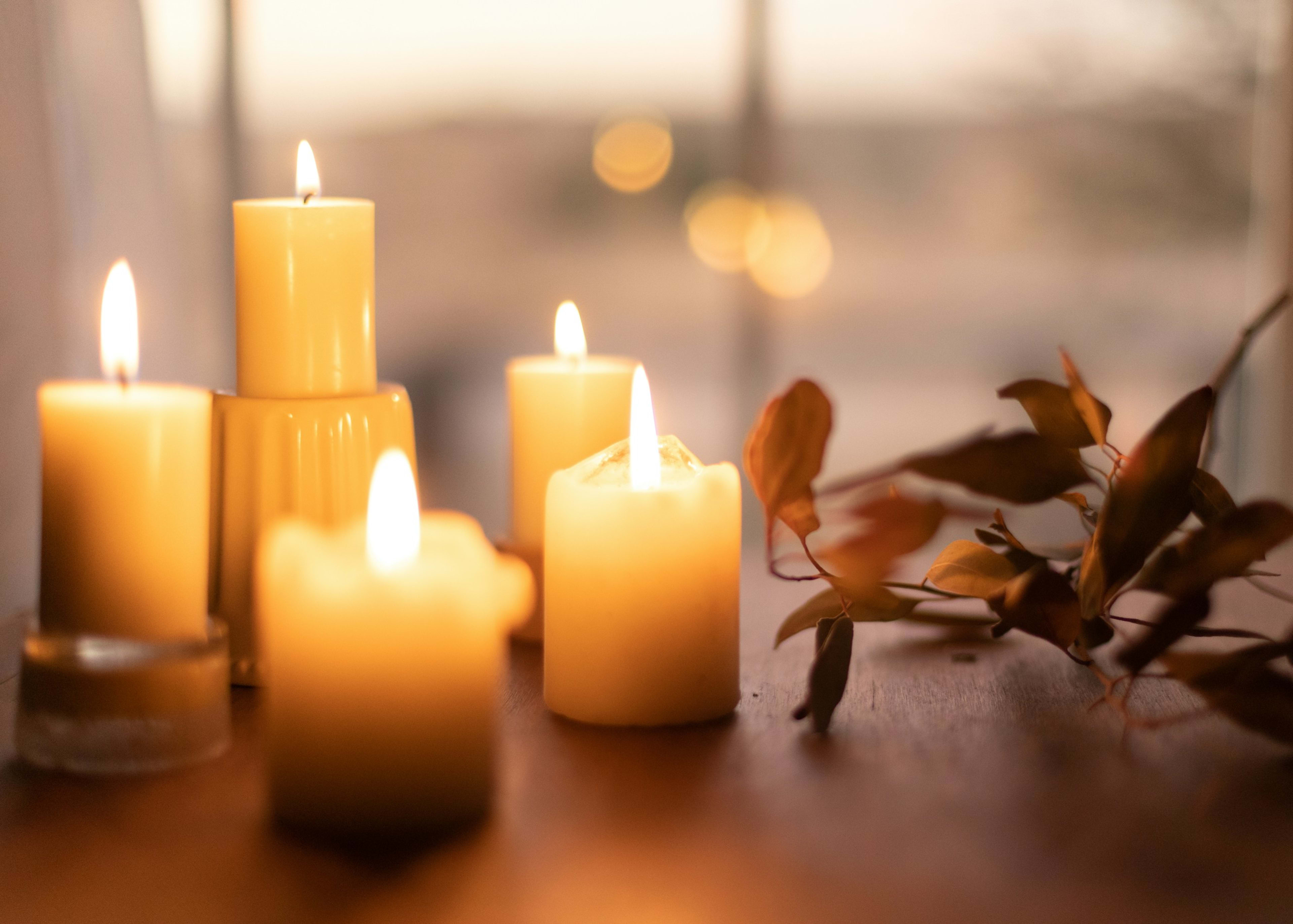 Candles glowing on a wooden table