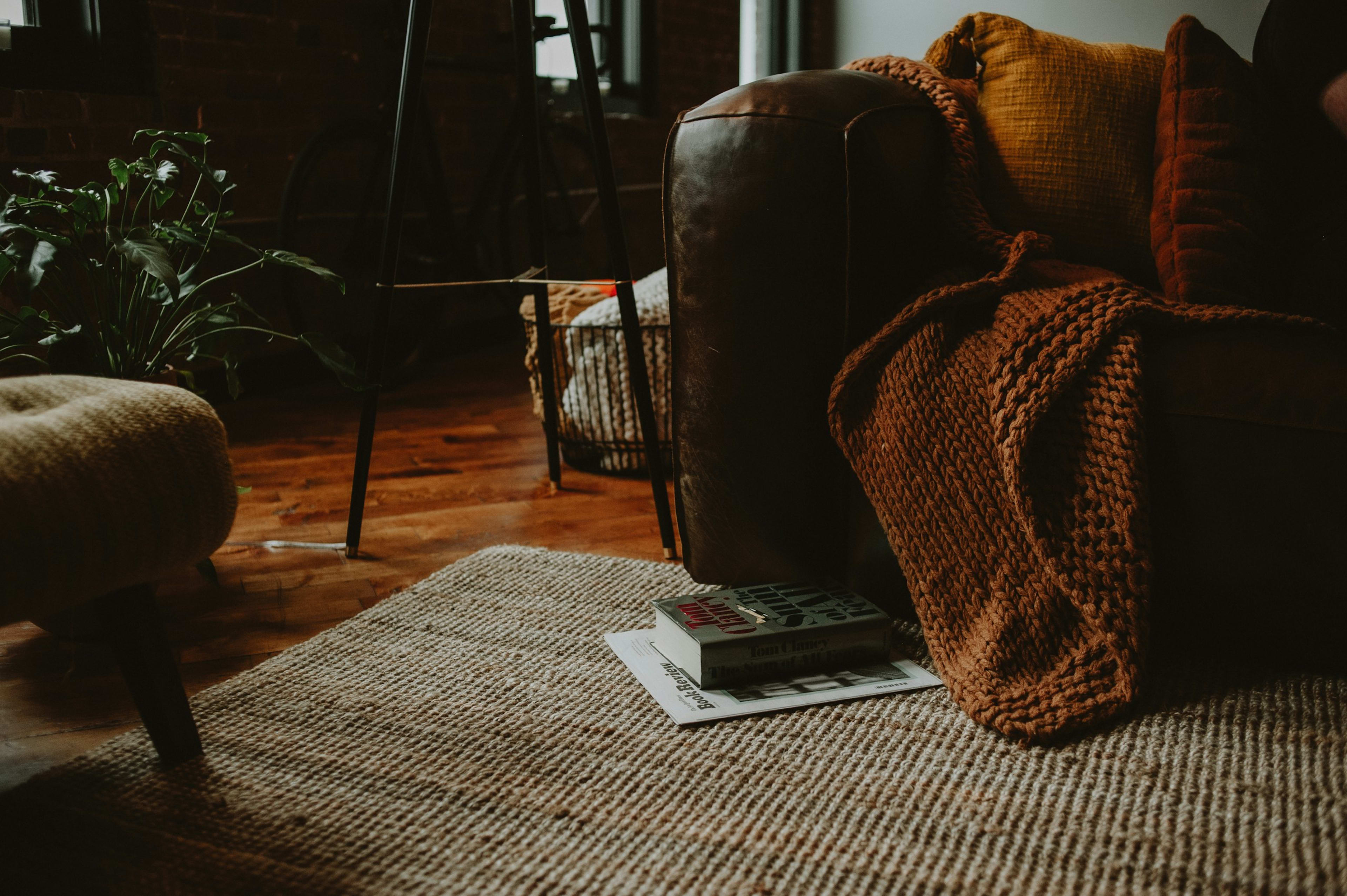 A knitted throw on a leather armchair