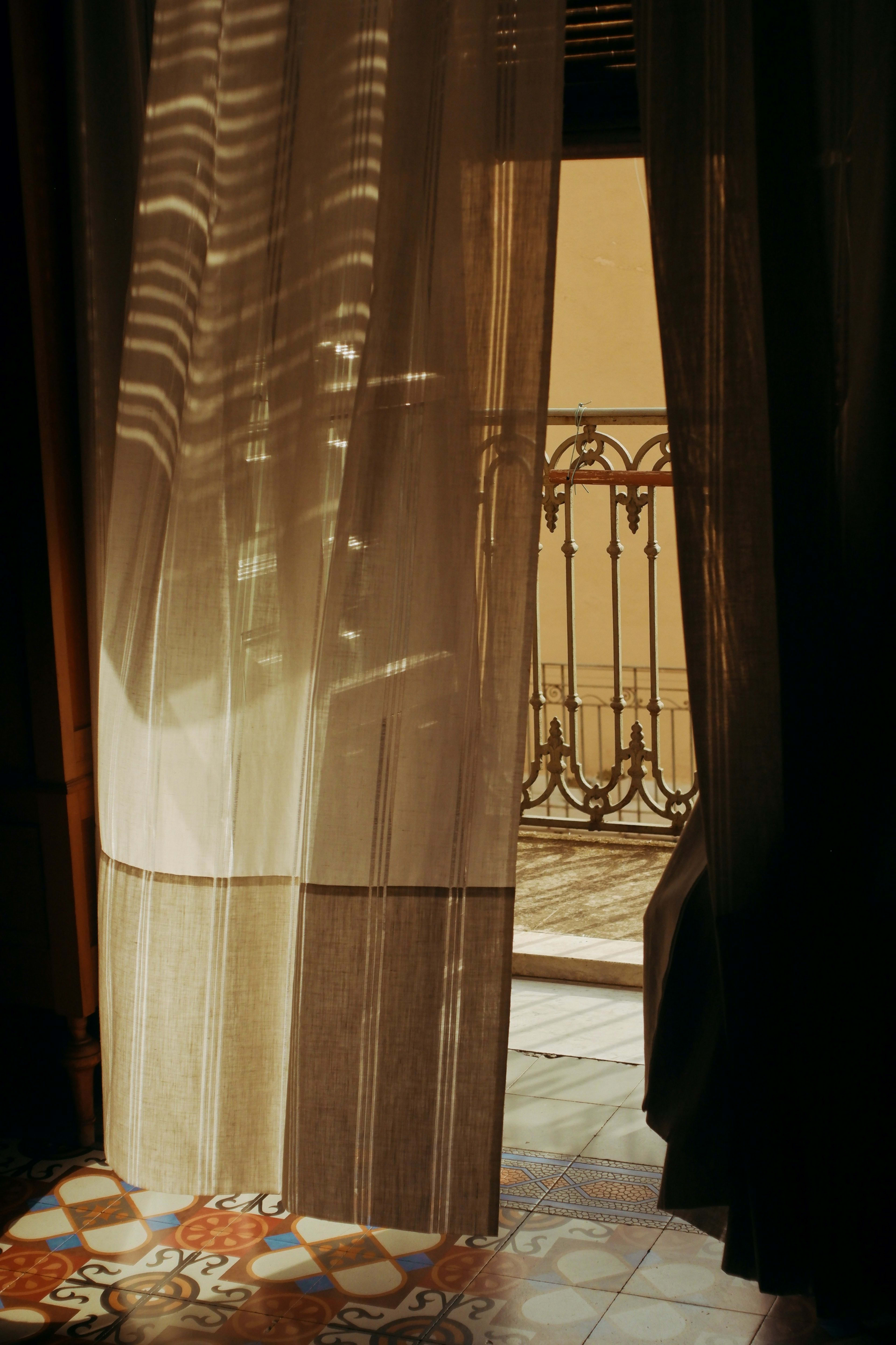 Sheer curtains glowing in warm evening light