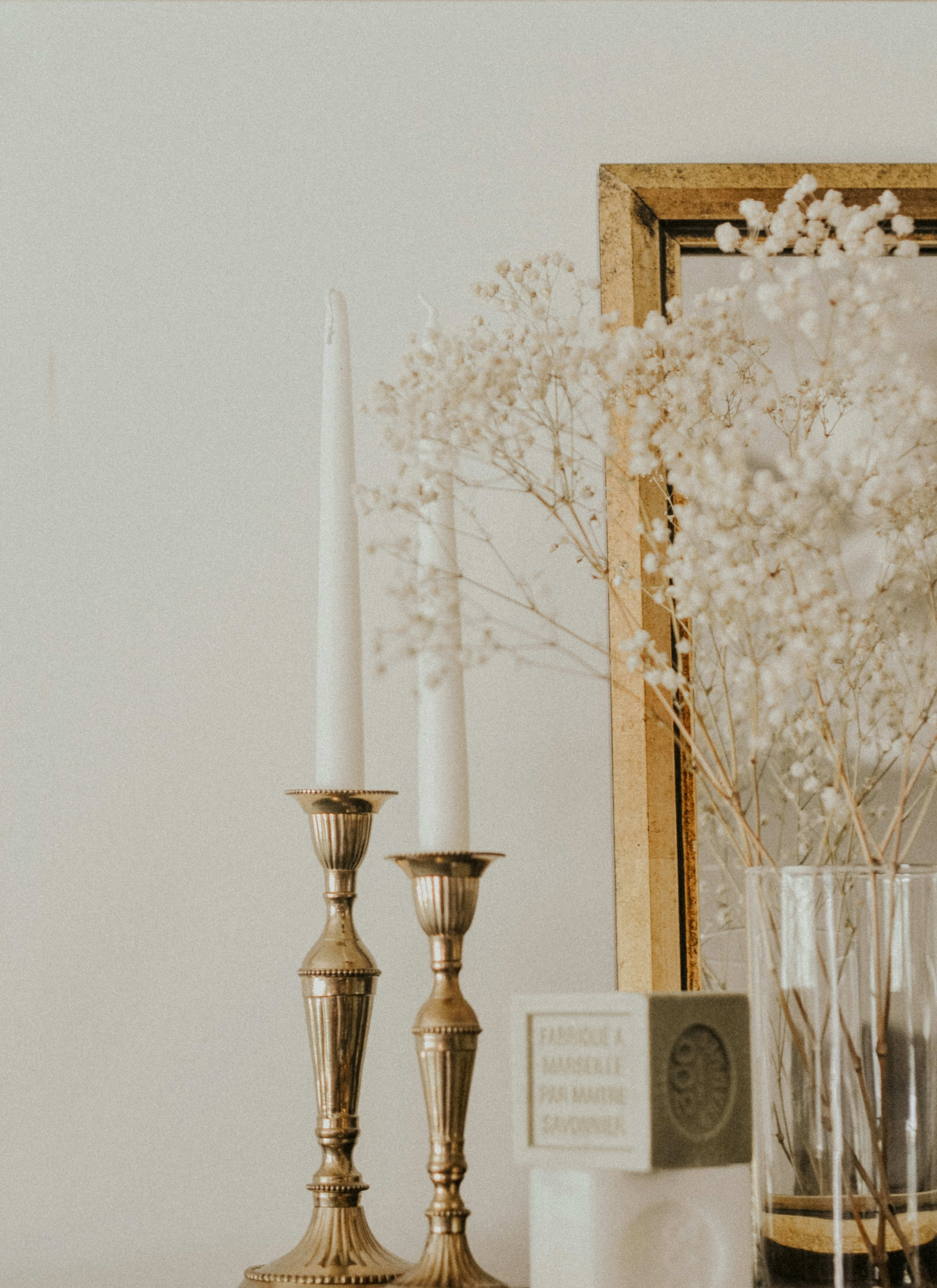 Brass candlesticks with dried flowers