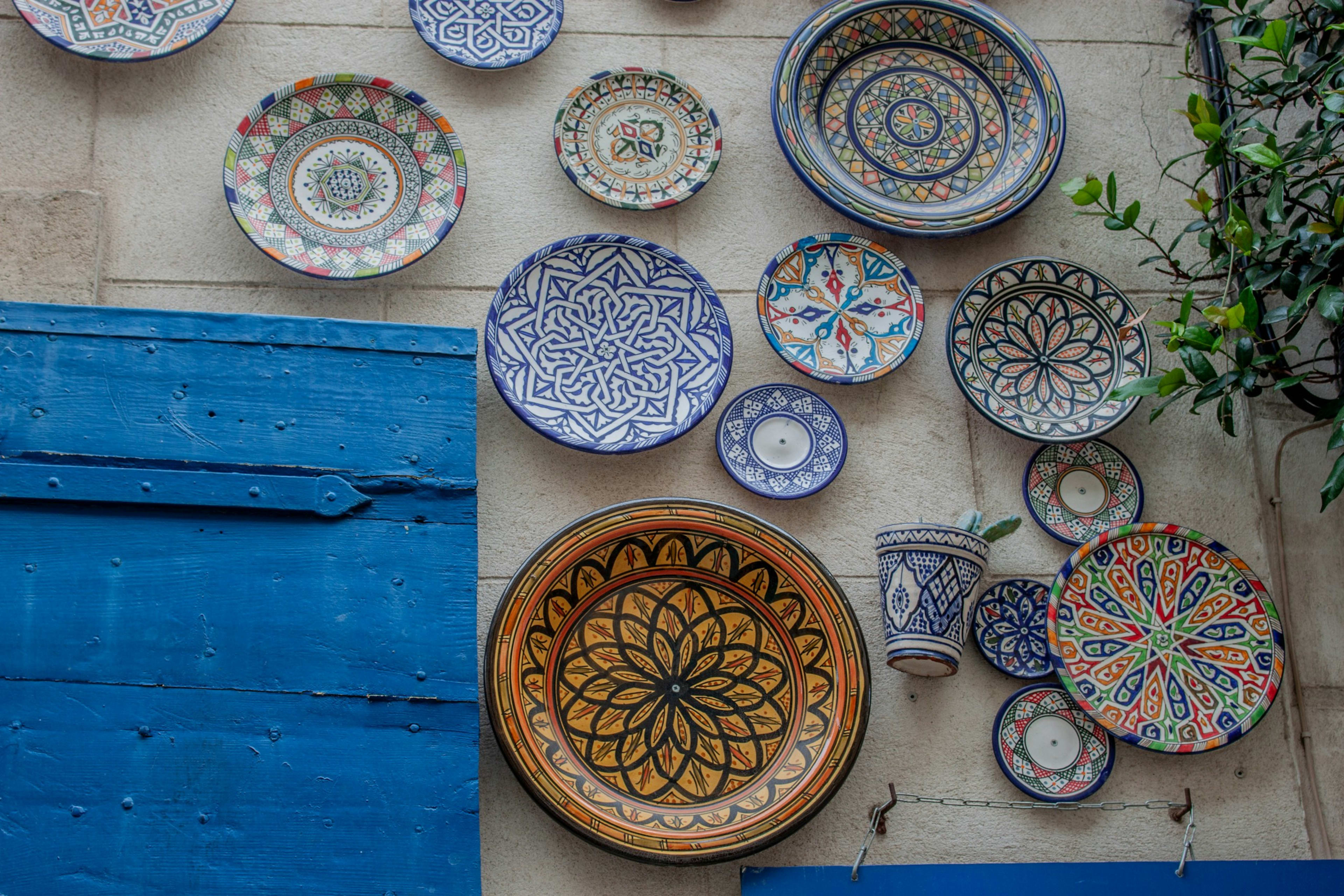 Hand-painted plates on a sunlit wall
