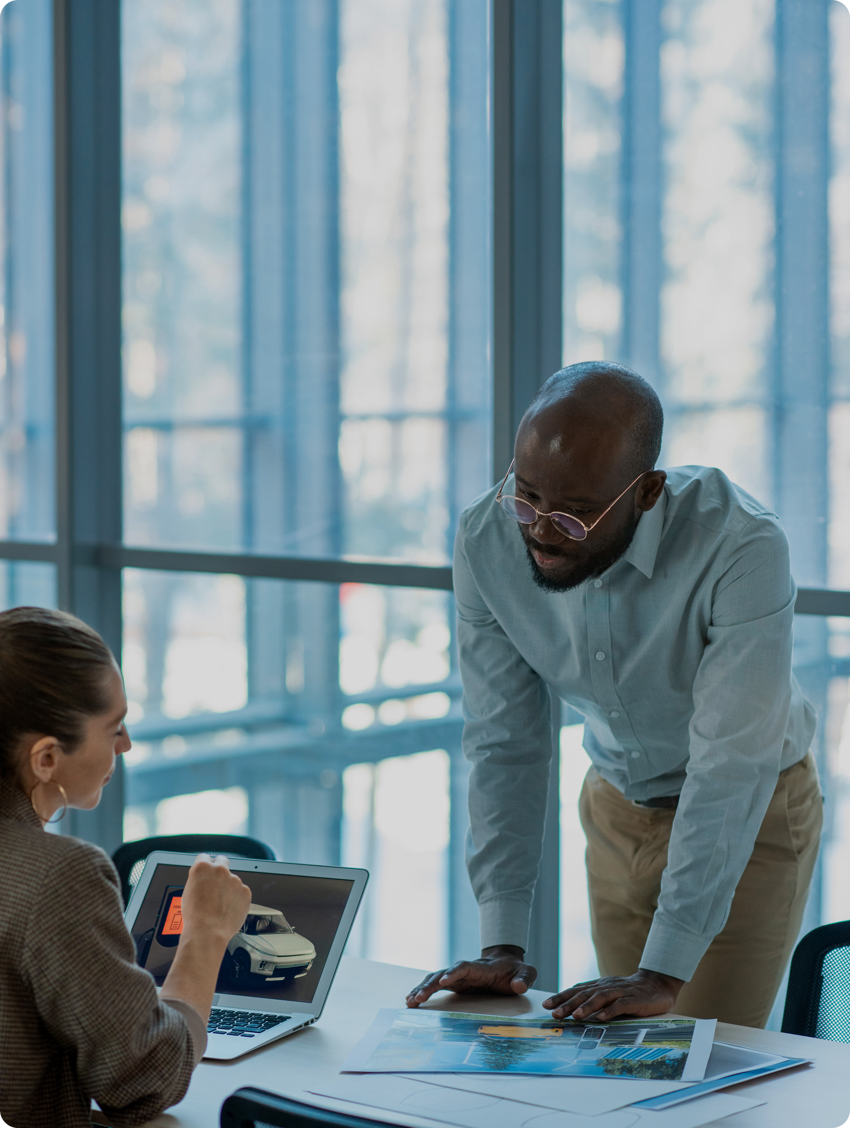 Advisor reviewing international mobility documents with a client in a modern office