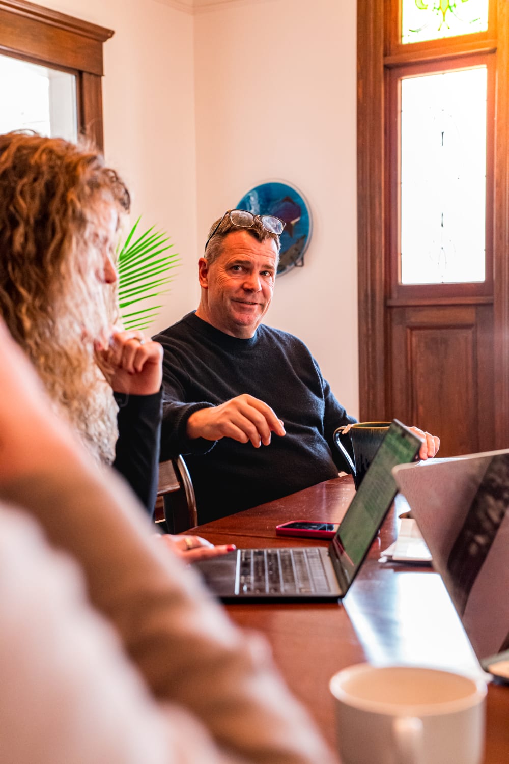 A Bennett Family Real Estate team member in conversation at the office
