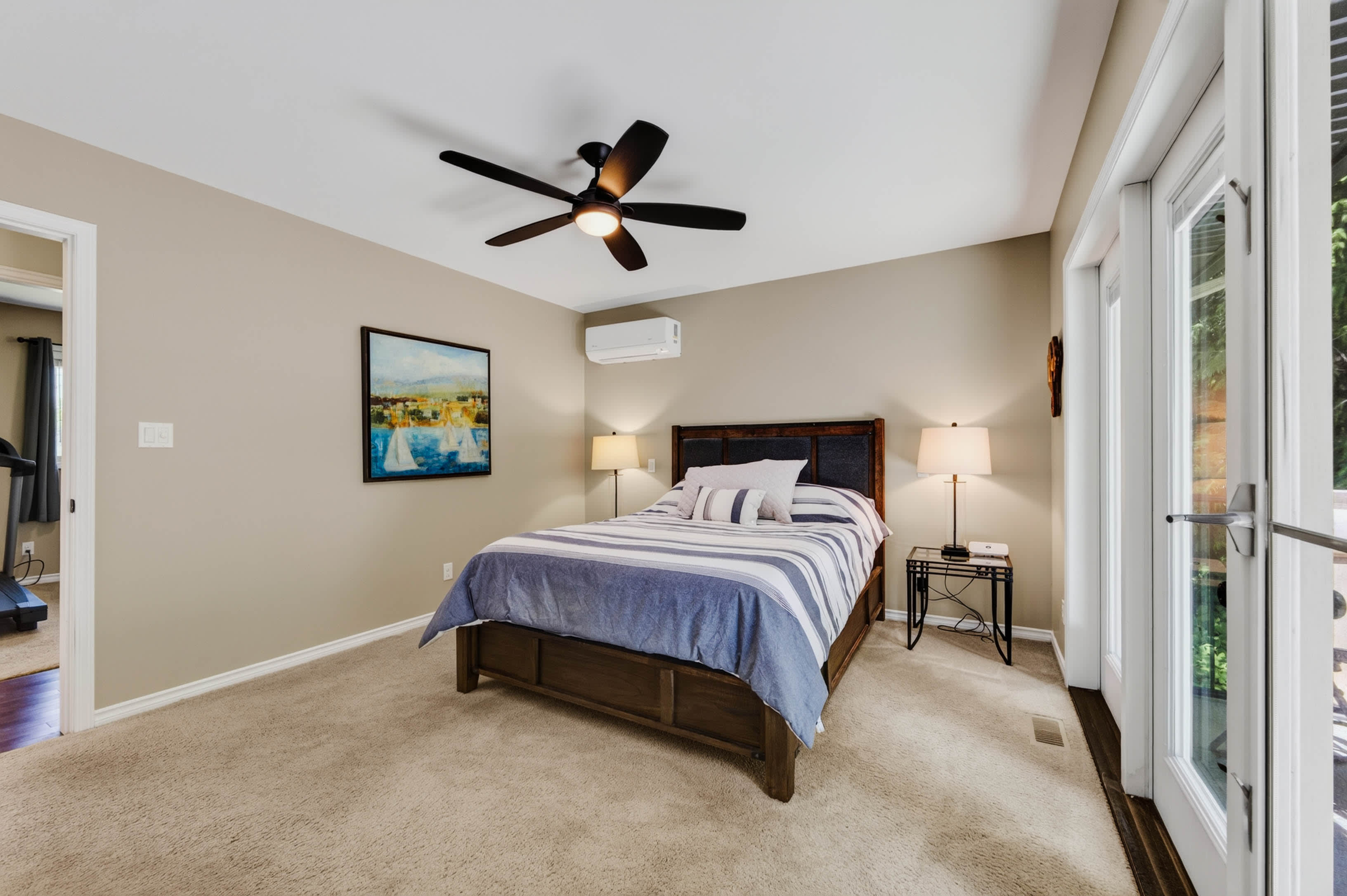 Primary bedroom with French doors opening to the deck