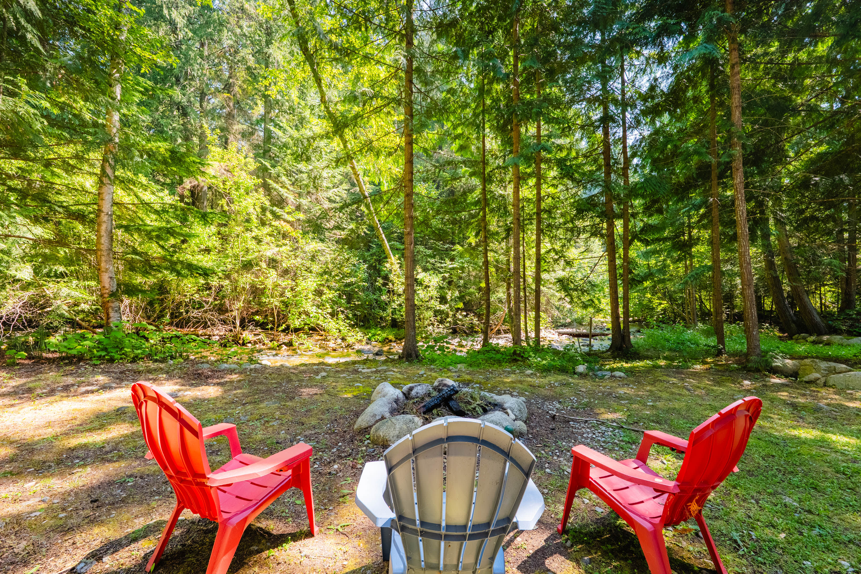 Secluded woodland firepit beside Redfish Creek