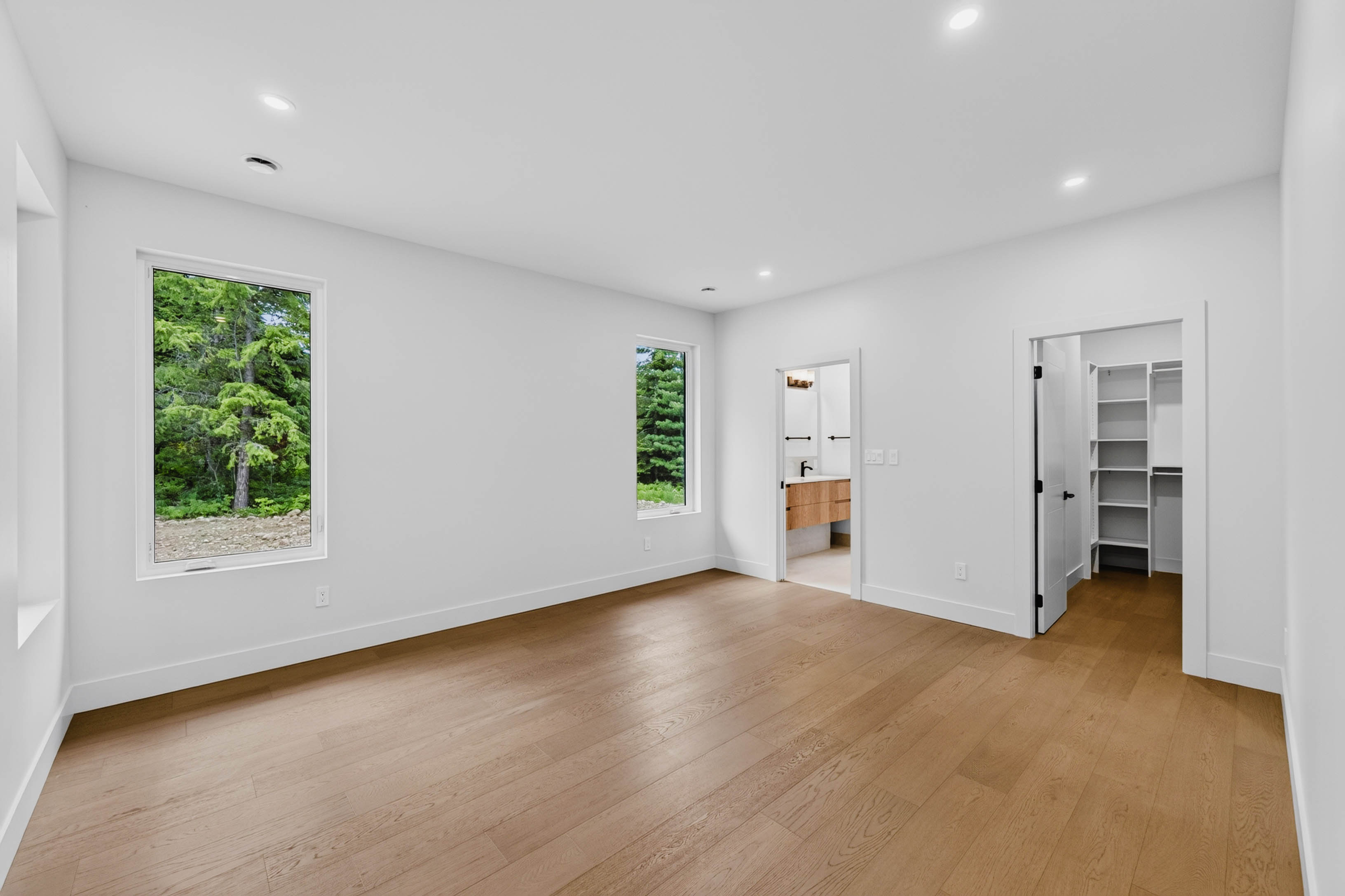 Primary bedroom at 7769 Holt Road with ensuite and walk-in closet access