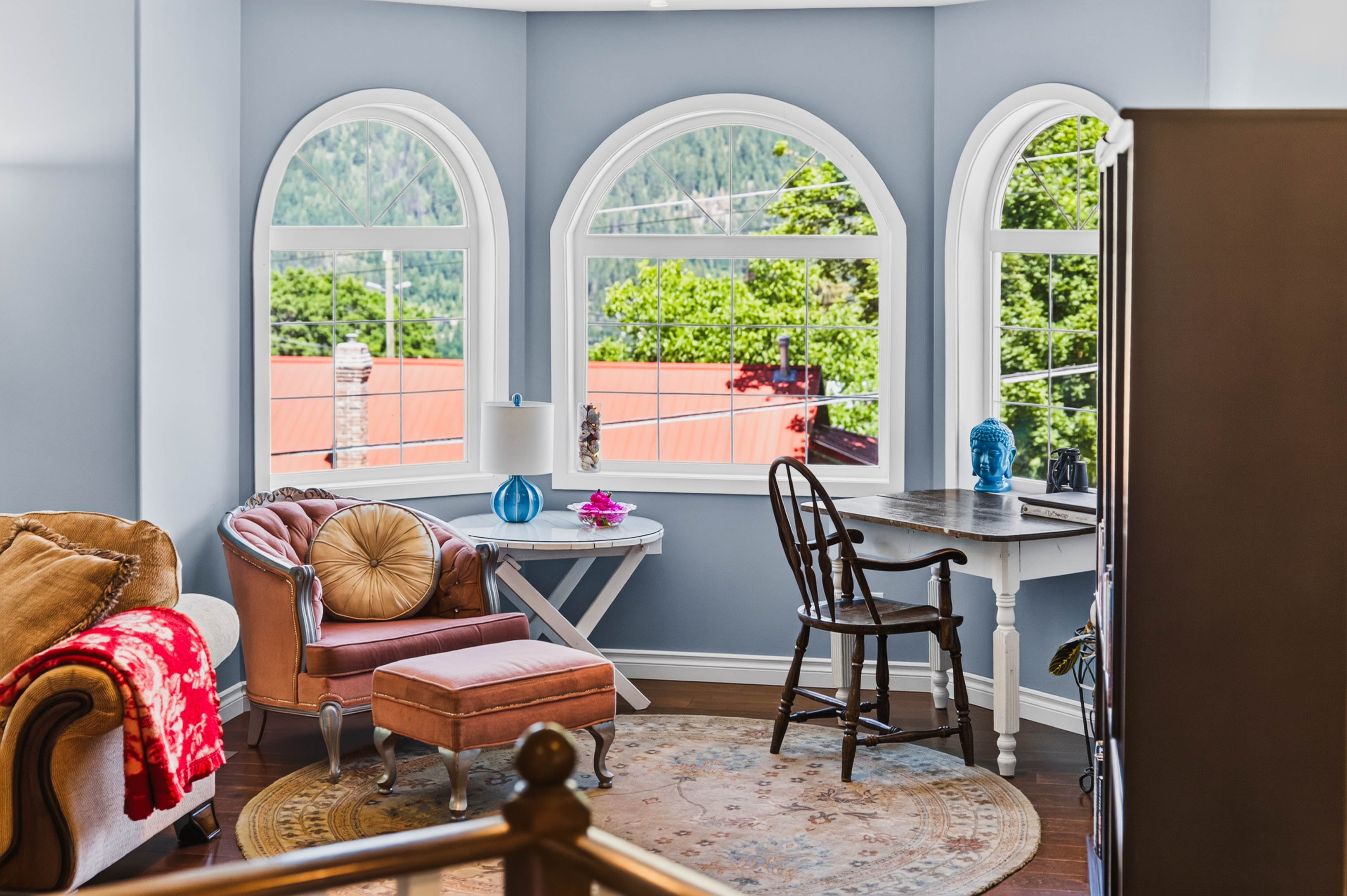 Bright living area with arched windows and mountain views