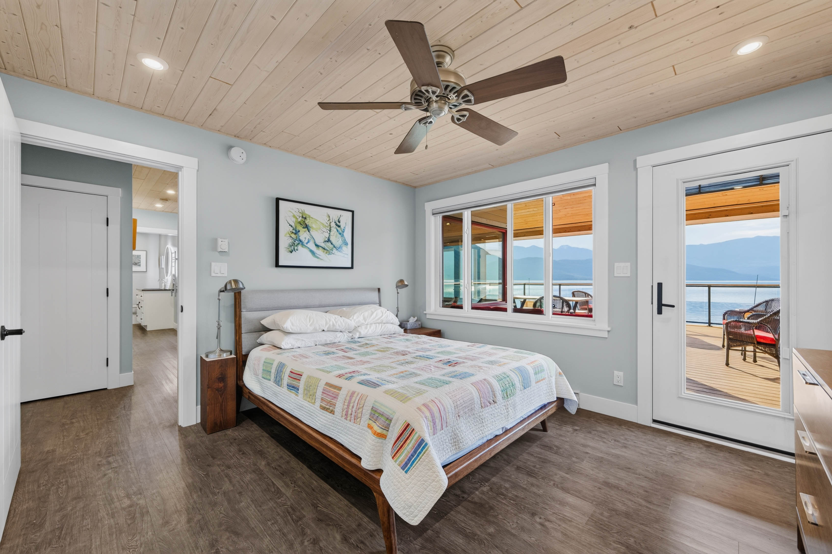 One of two bedrooms in the main home with deck access and lake view