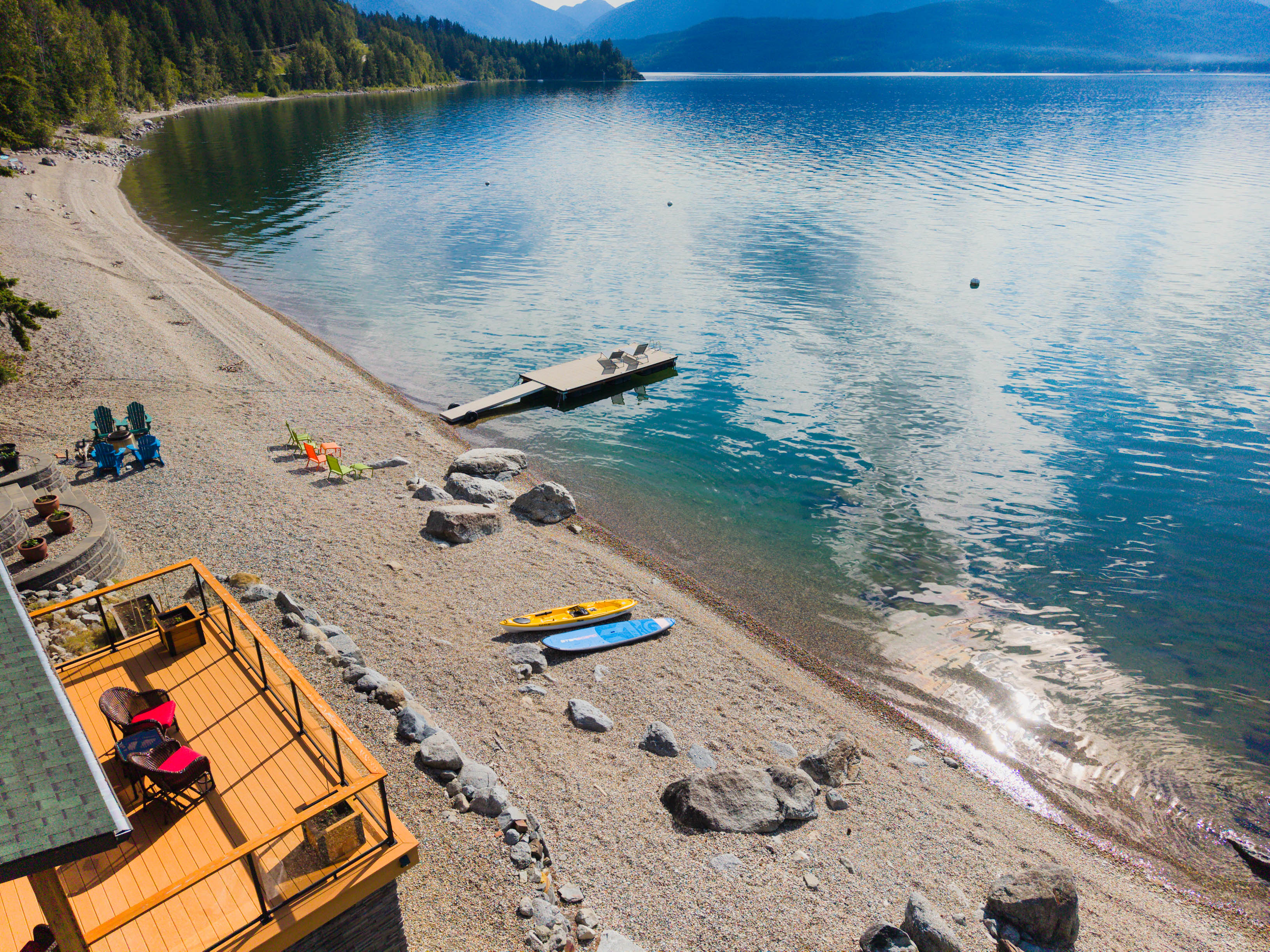 Beach, dock, paddleboards and Kootenay Lake shoreline
