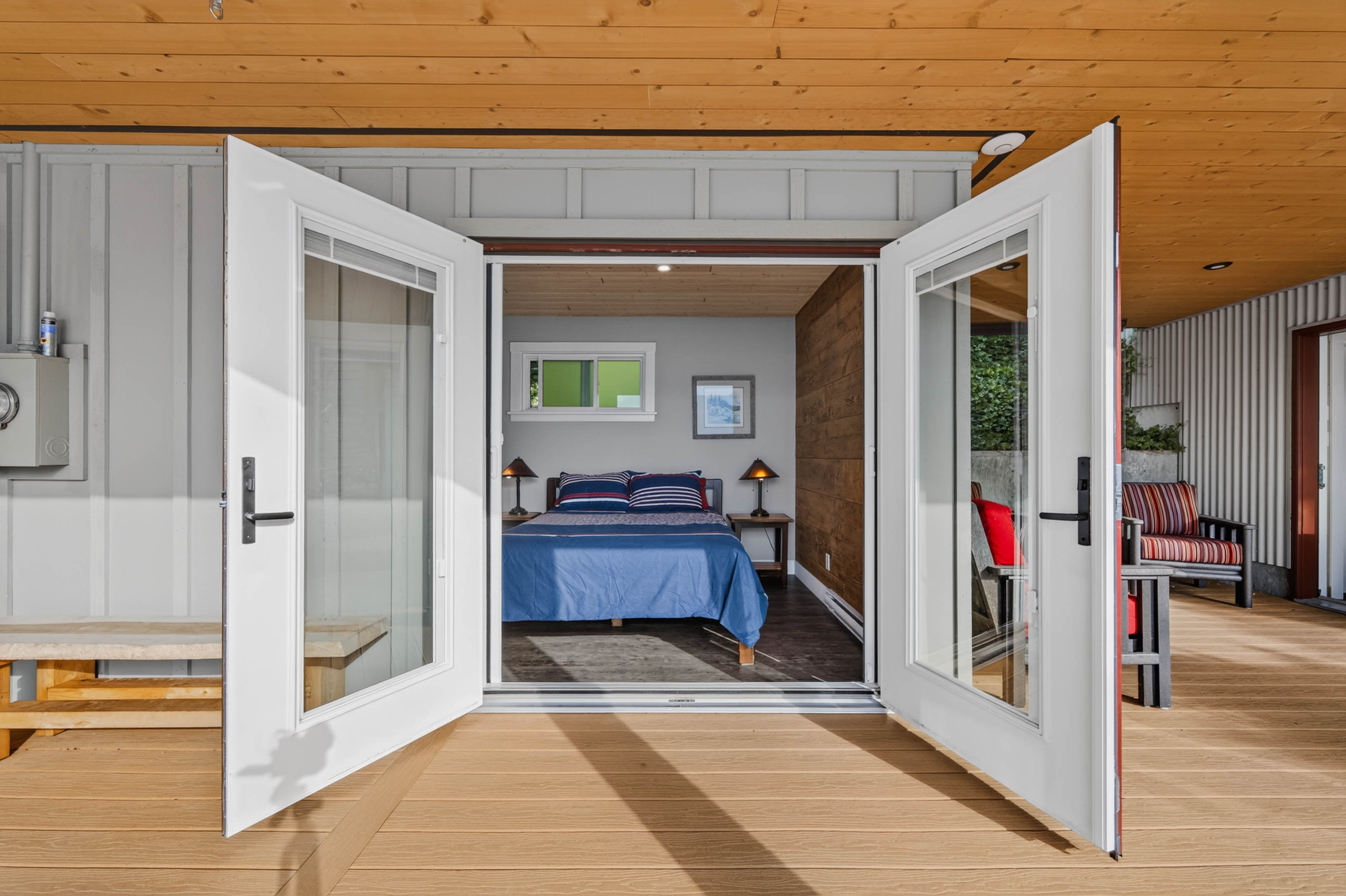 Detached bunkhouse bedroom opening to a covered deck
