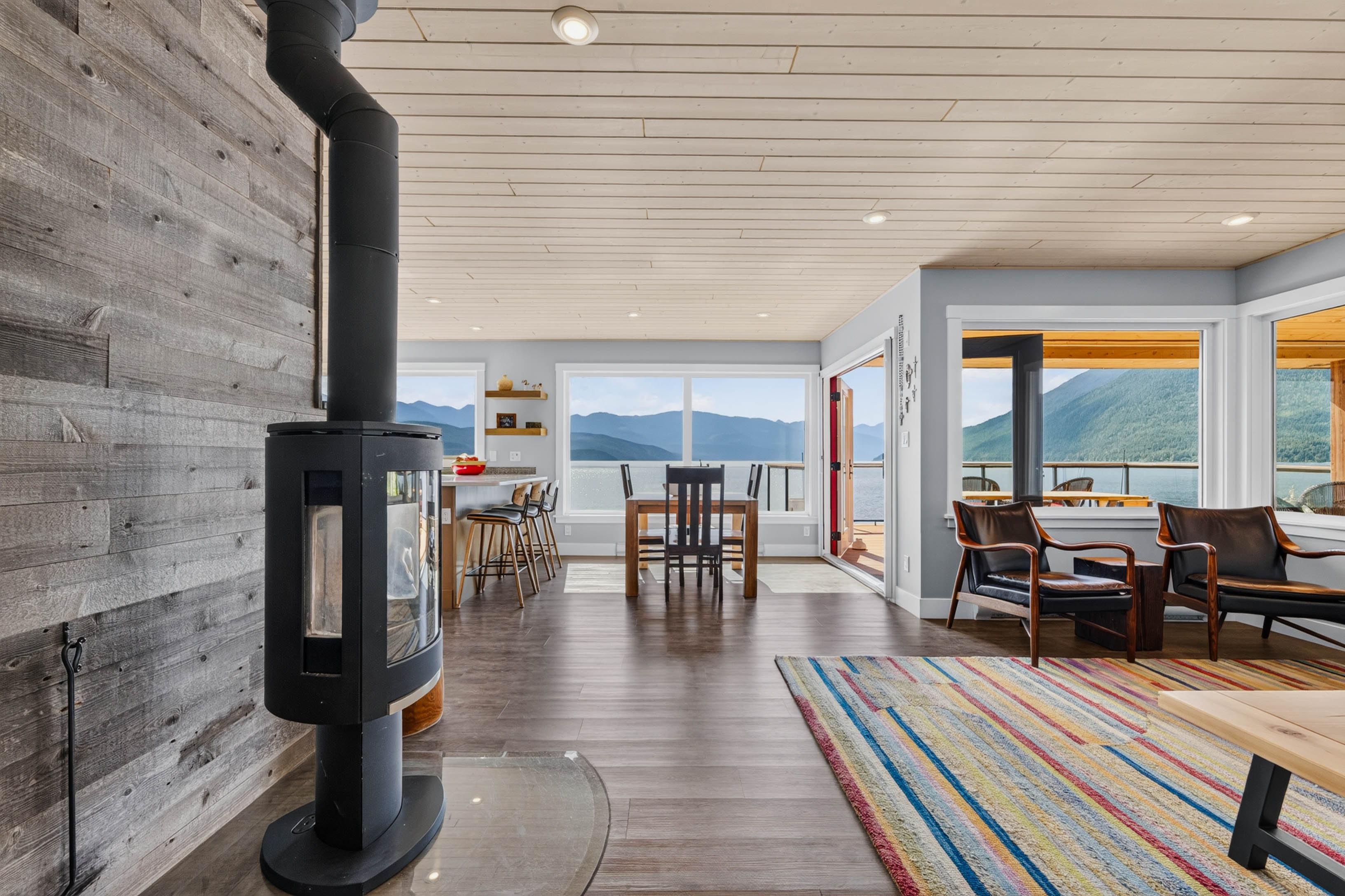 Living room with wood stove and lake view