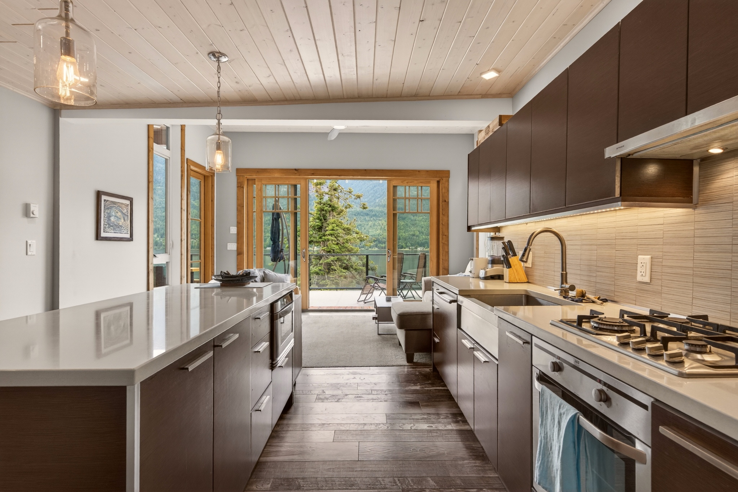 Renovated kitchen looking toward the deck and Kootenay Lake