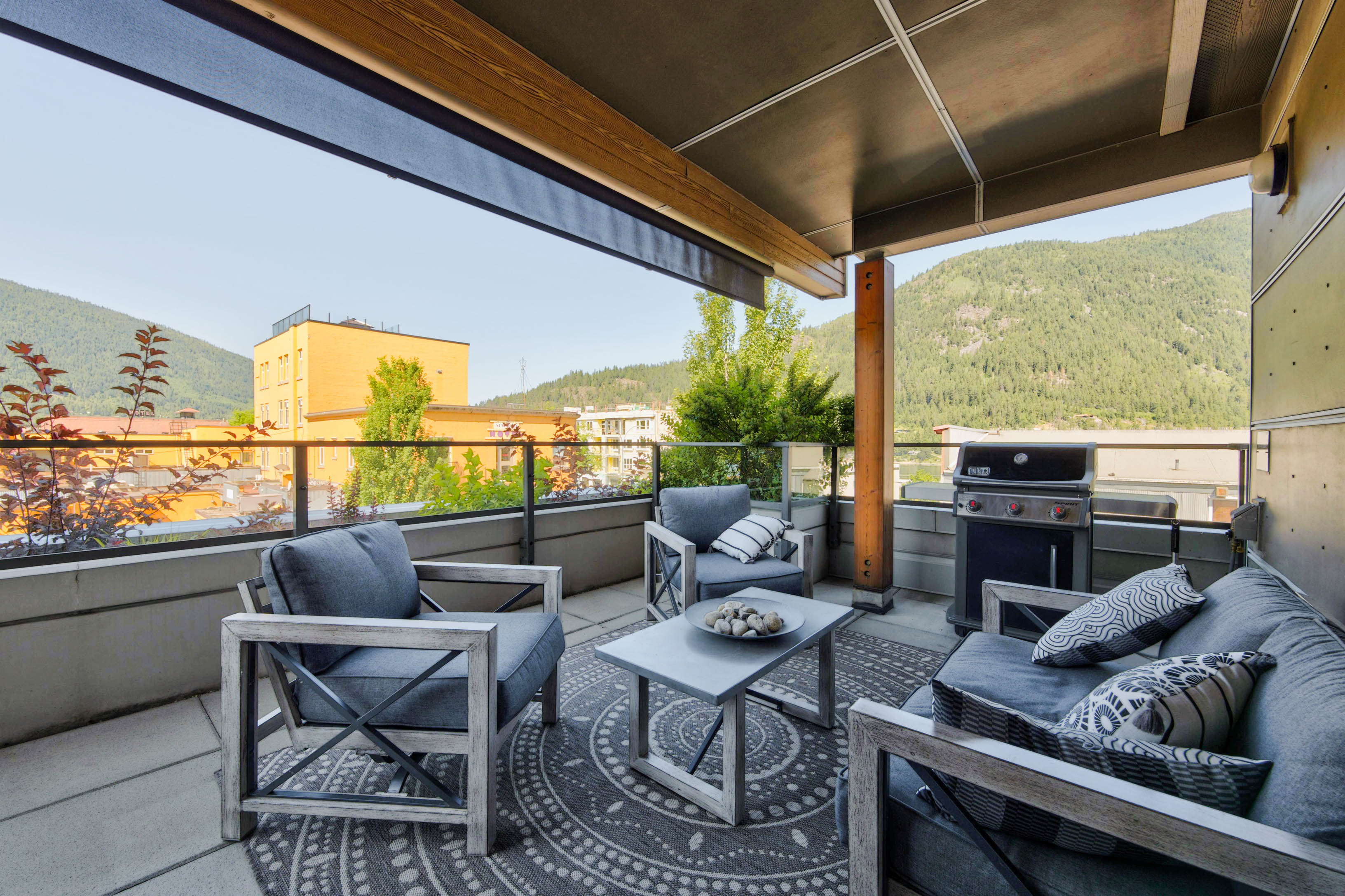 Covered deck with seating, barbecue and mountain outlook