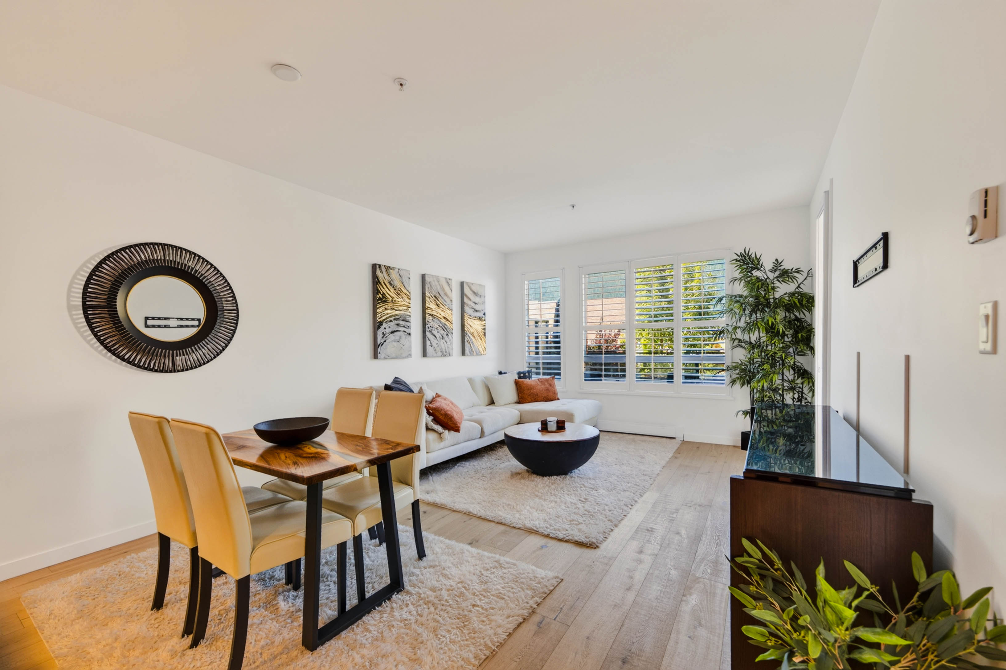 Bright open-concept living and dining area at 215–710 Vernon Street