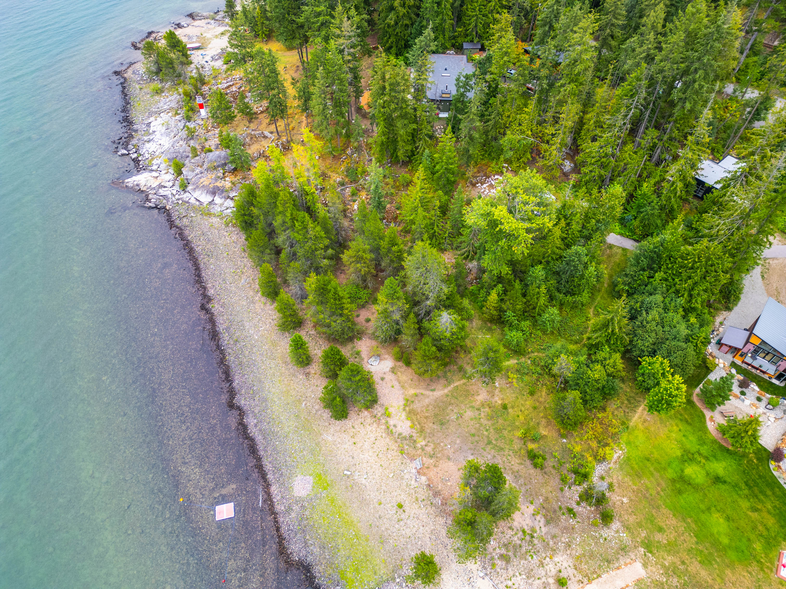 Aerial view of the forested property and its long Kootenay Lake shoreline