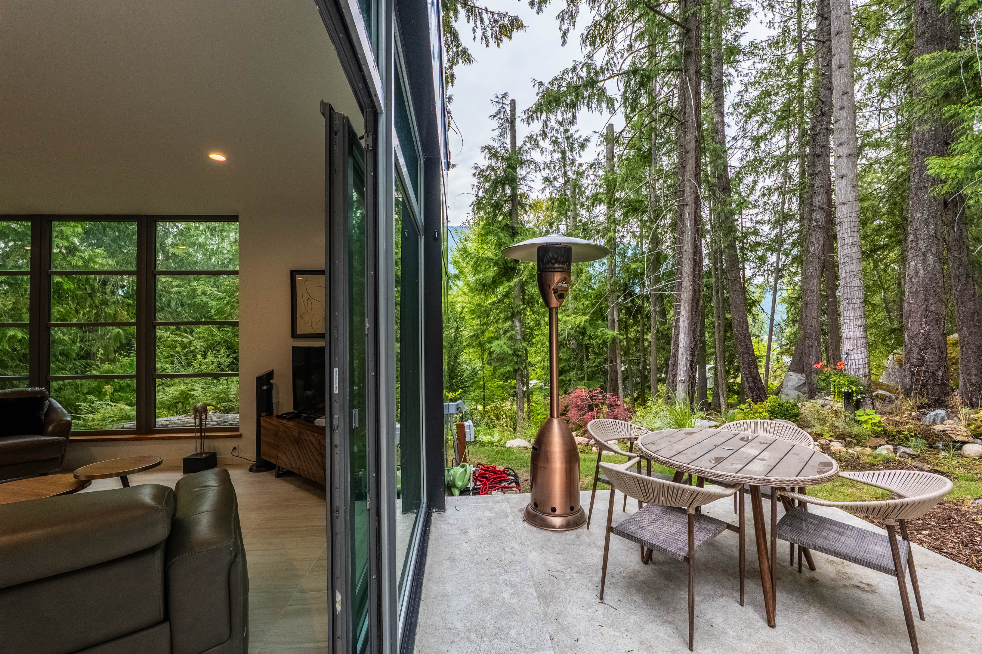 Patio and indoor-outdoor living beside the forest