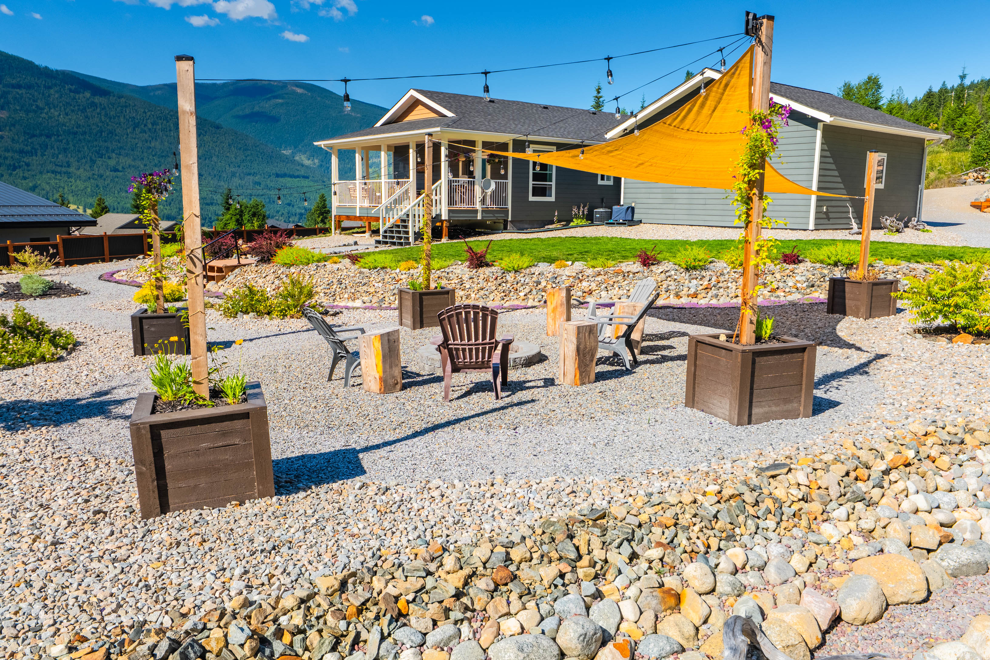 Outdoor fire-pit gathering area at 430 Buriview Drive with the home and covered deck behind