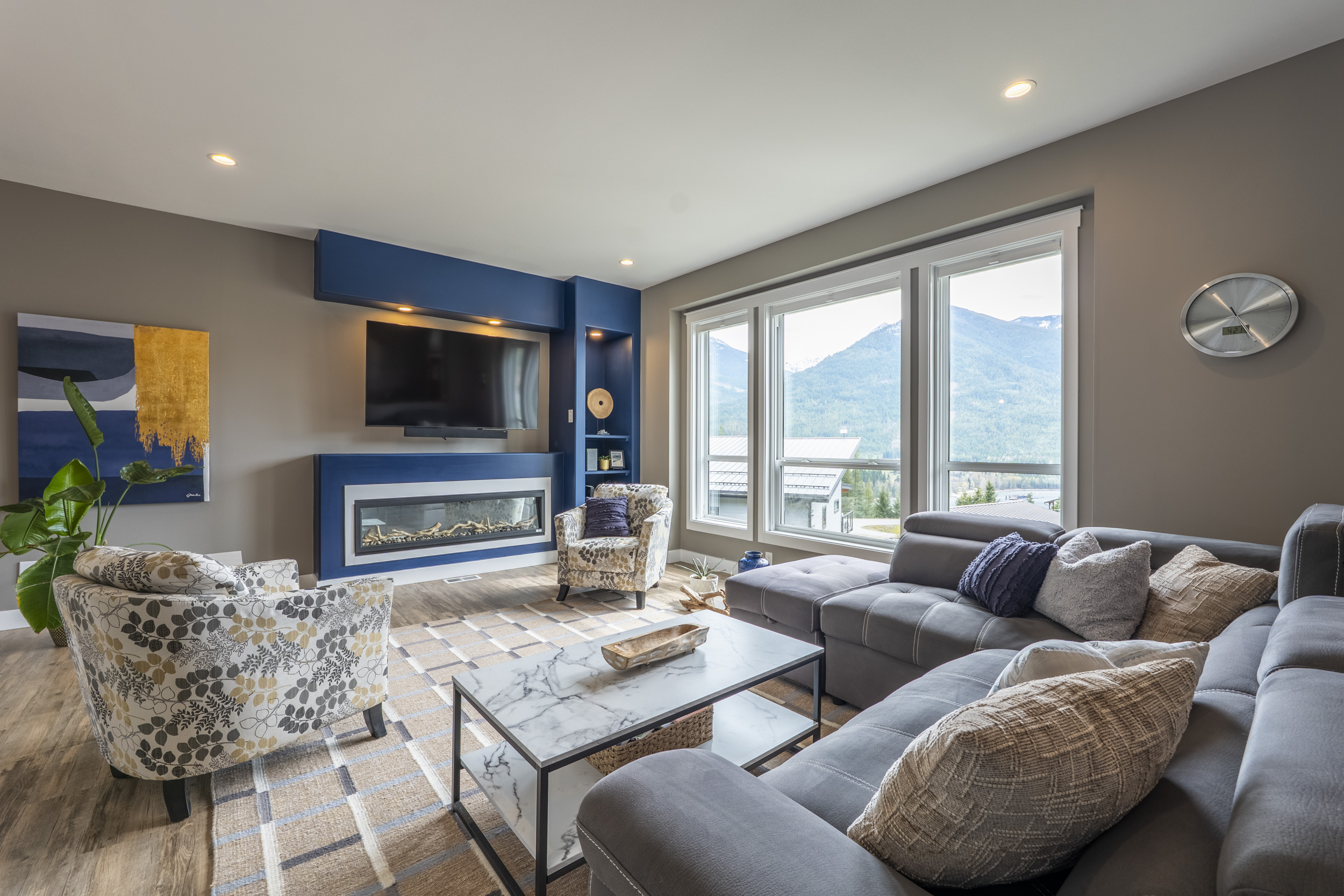 Bright living room at 430 Buriview Drive with modern fireplace and mountain views through large windows