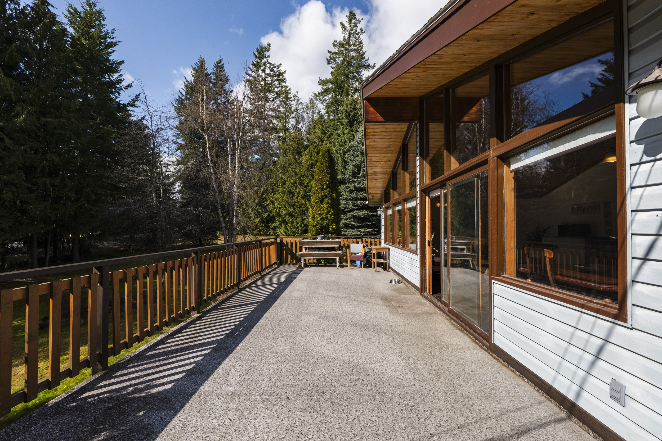 Wraparound deck surrounded by trees at 7077 Beggs Road