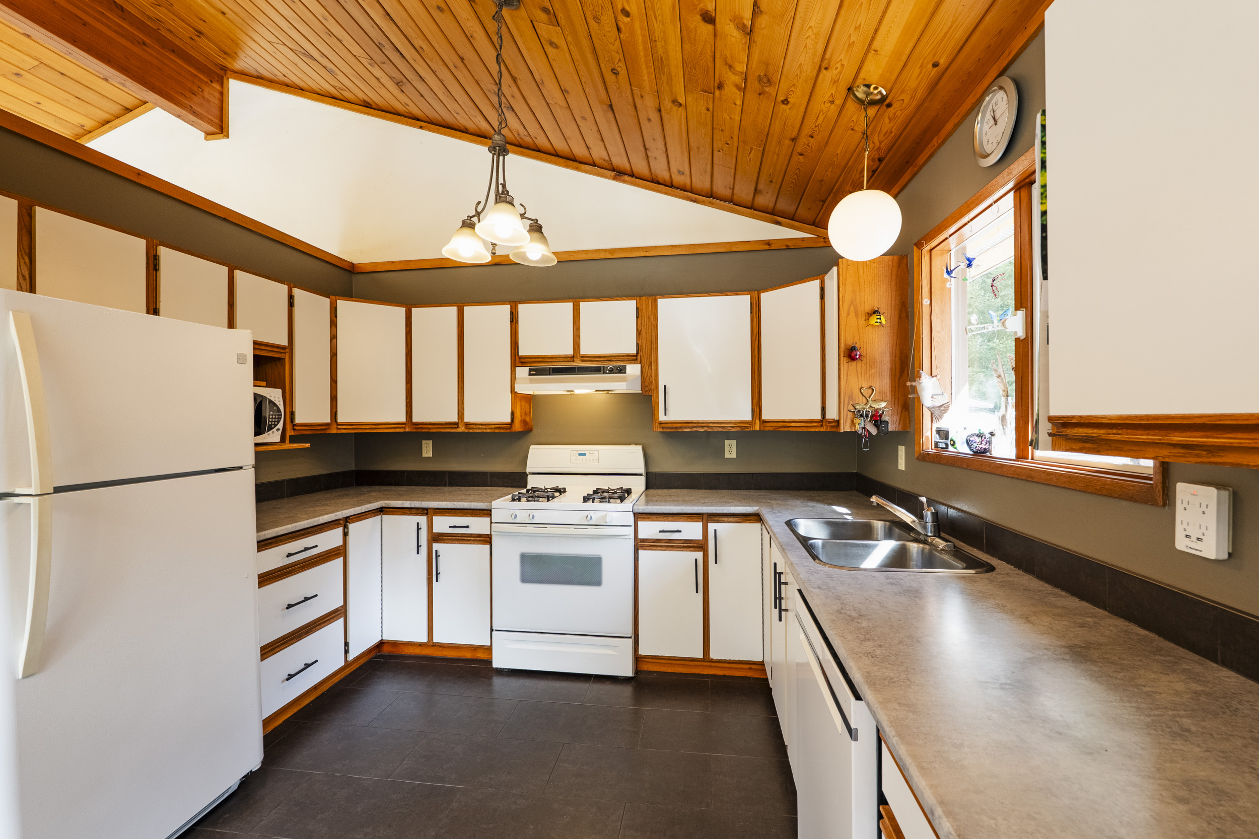 Spacious kitchen beneath warm wood ceilings at 7077 Beggs Road