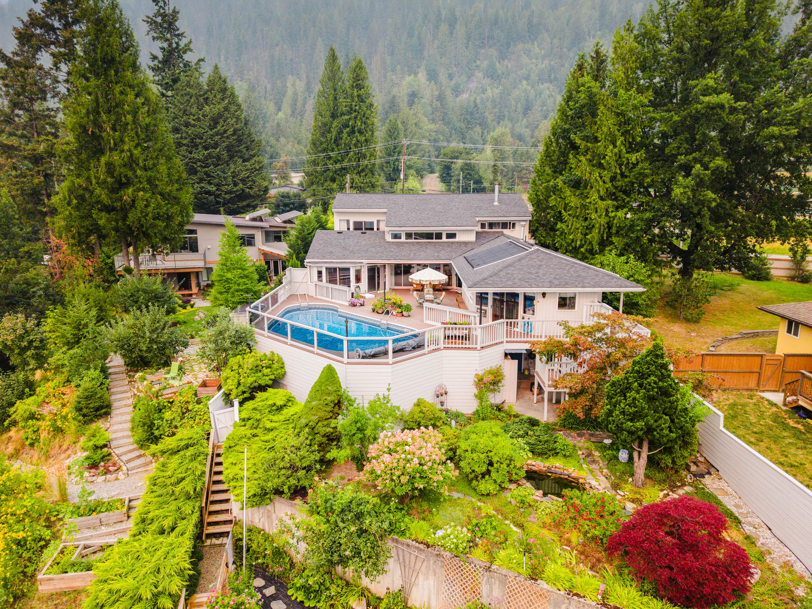 Aerial view of the waterfront home, pool and gardens at 1896 Highway 3A