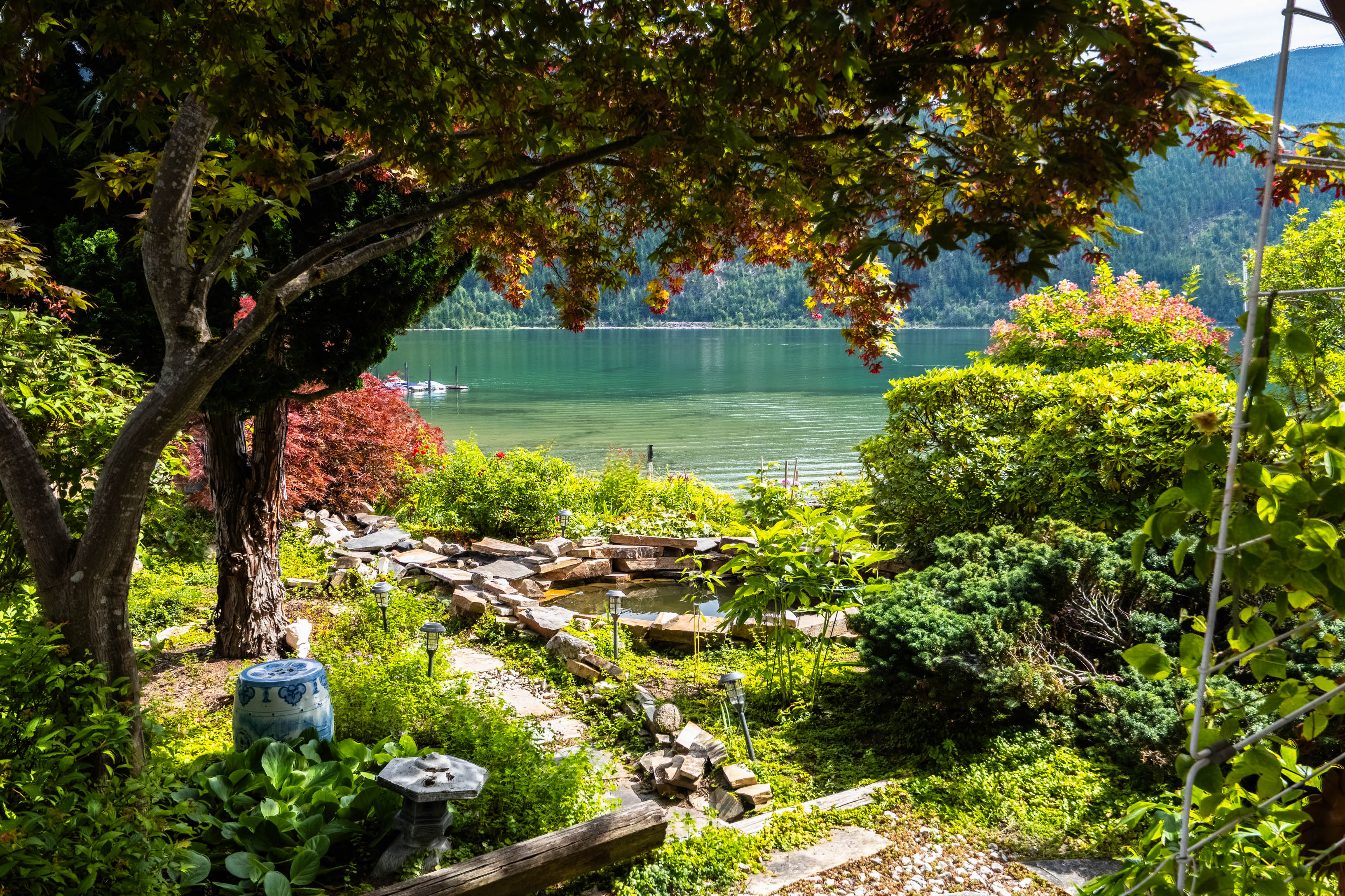 Garden, water feature and Kootenay Lake view