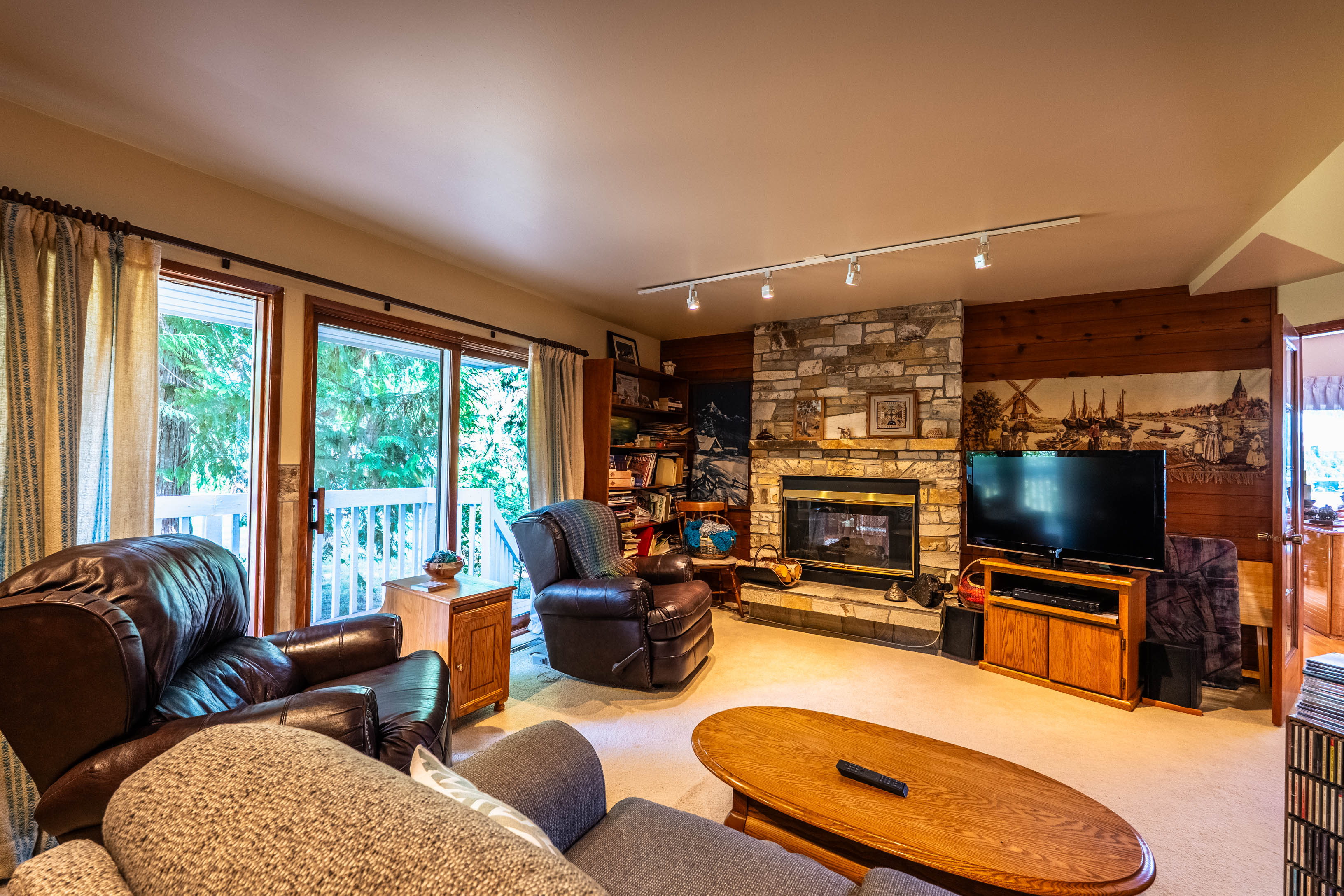 Study with fireplace, built-in shelving and deck access