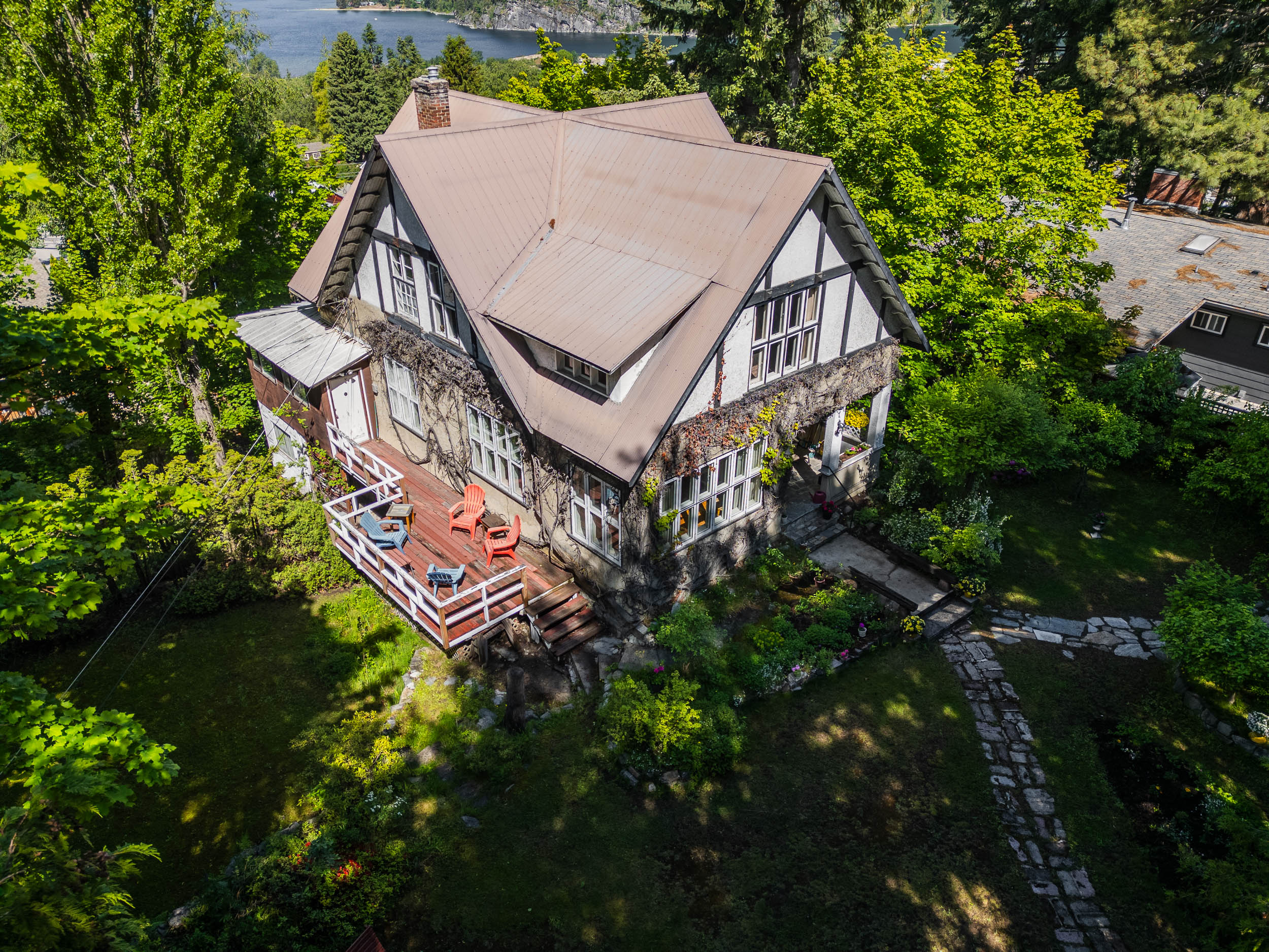 Aerial view of the Tudor Revival home and mature grounds