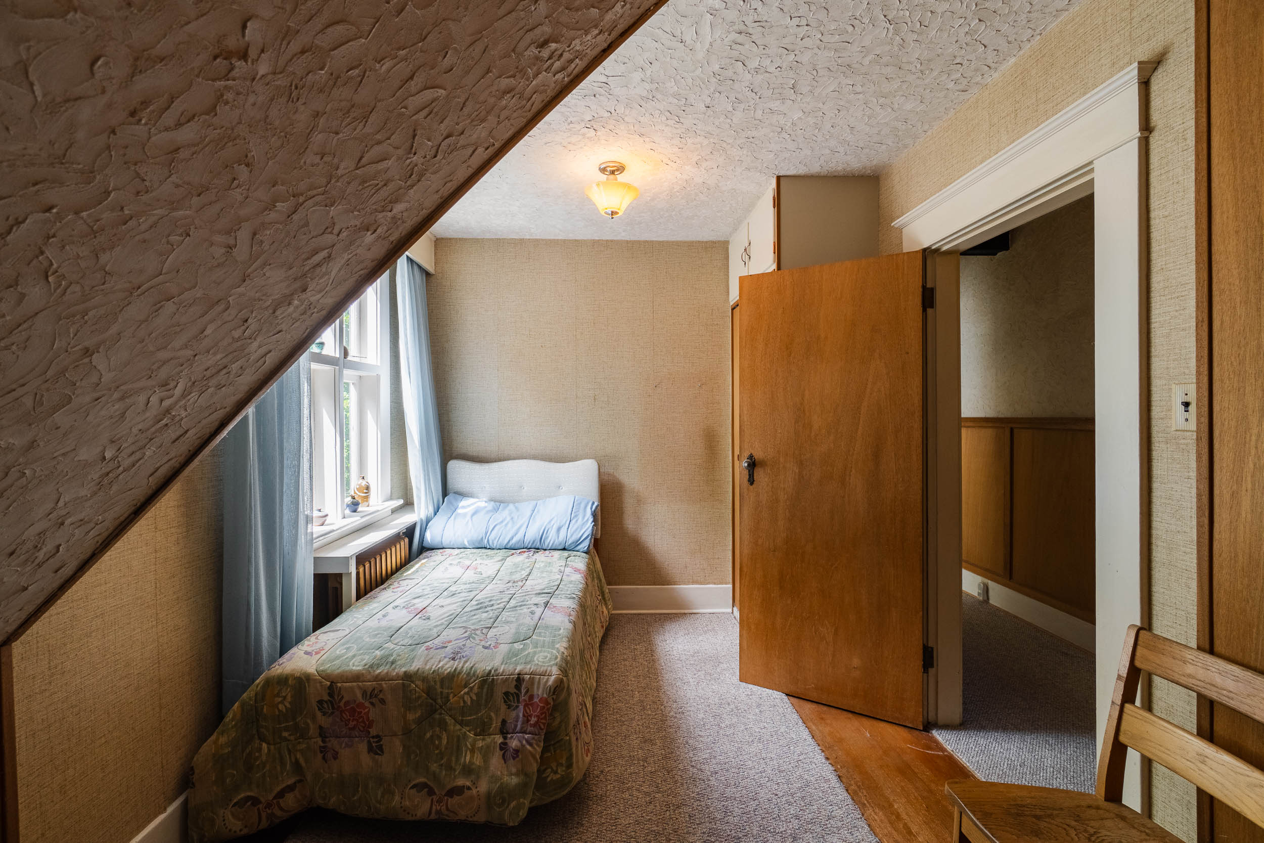 Bedroom beneath a sloped ceiling
