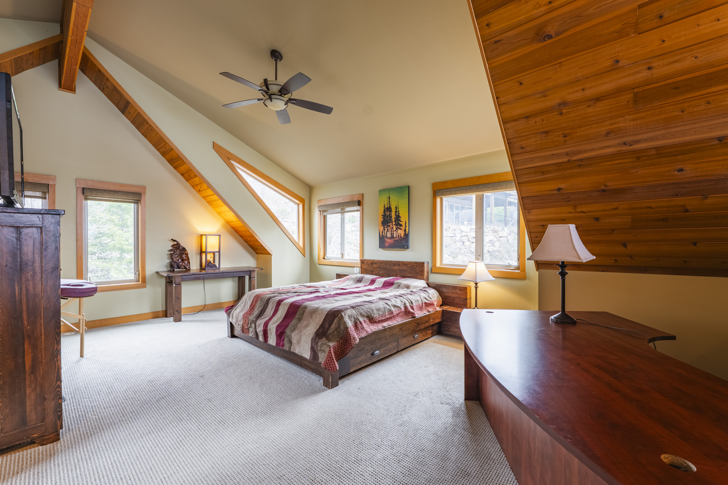 Spacious lofted primary bedroom with timber and wood details