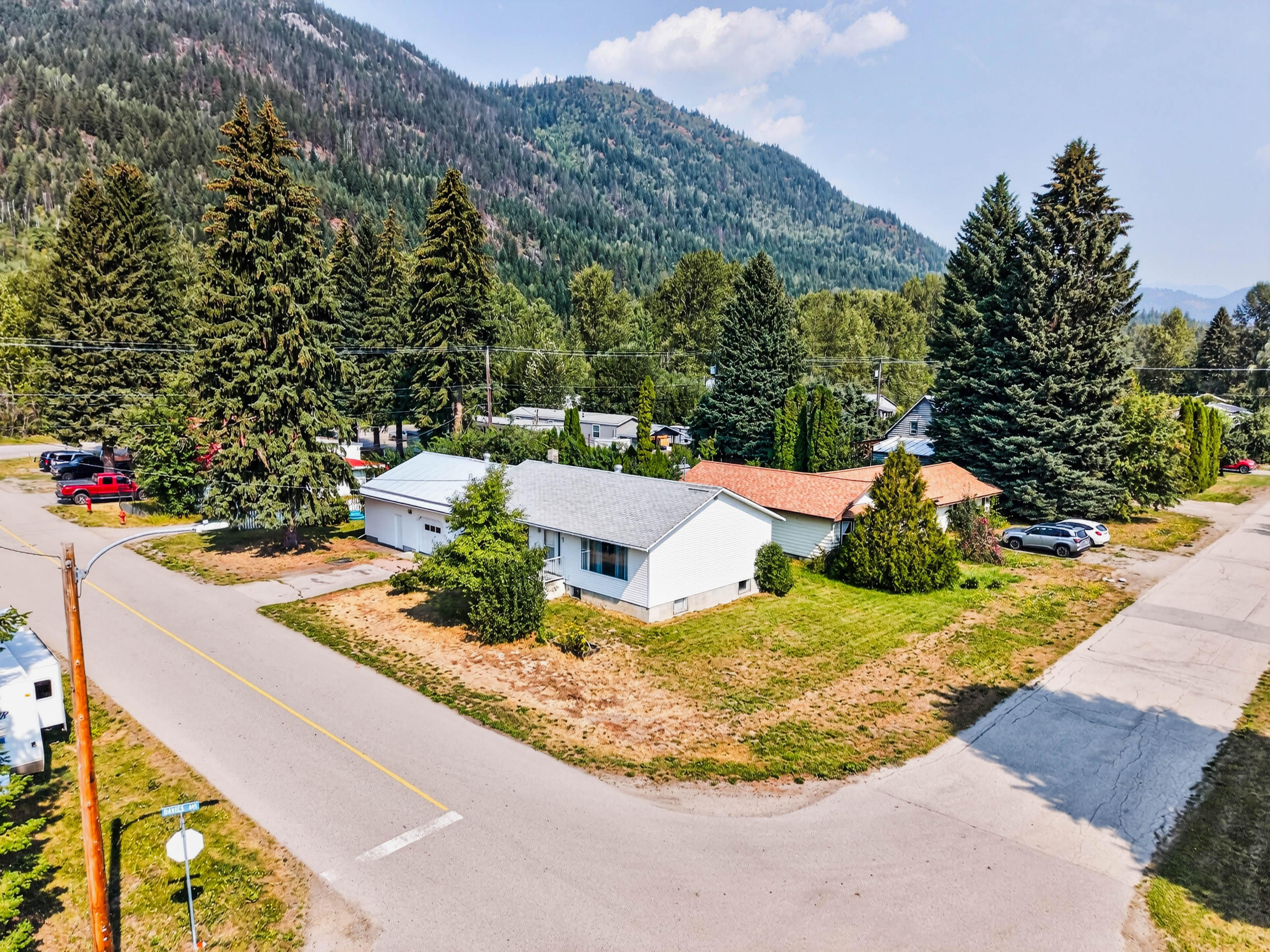 Aerial view of 115 Second Street on its corner property with the Salmo mountains beyond