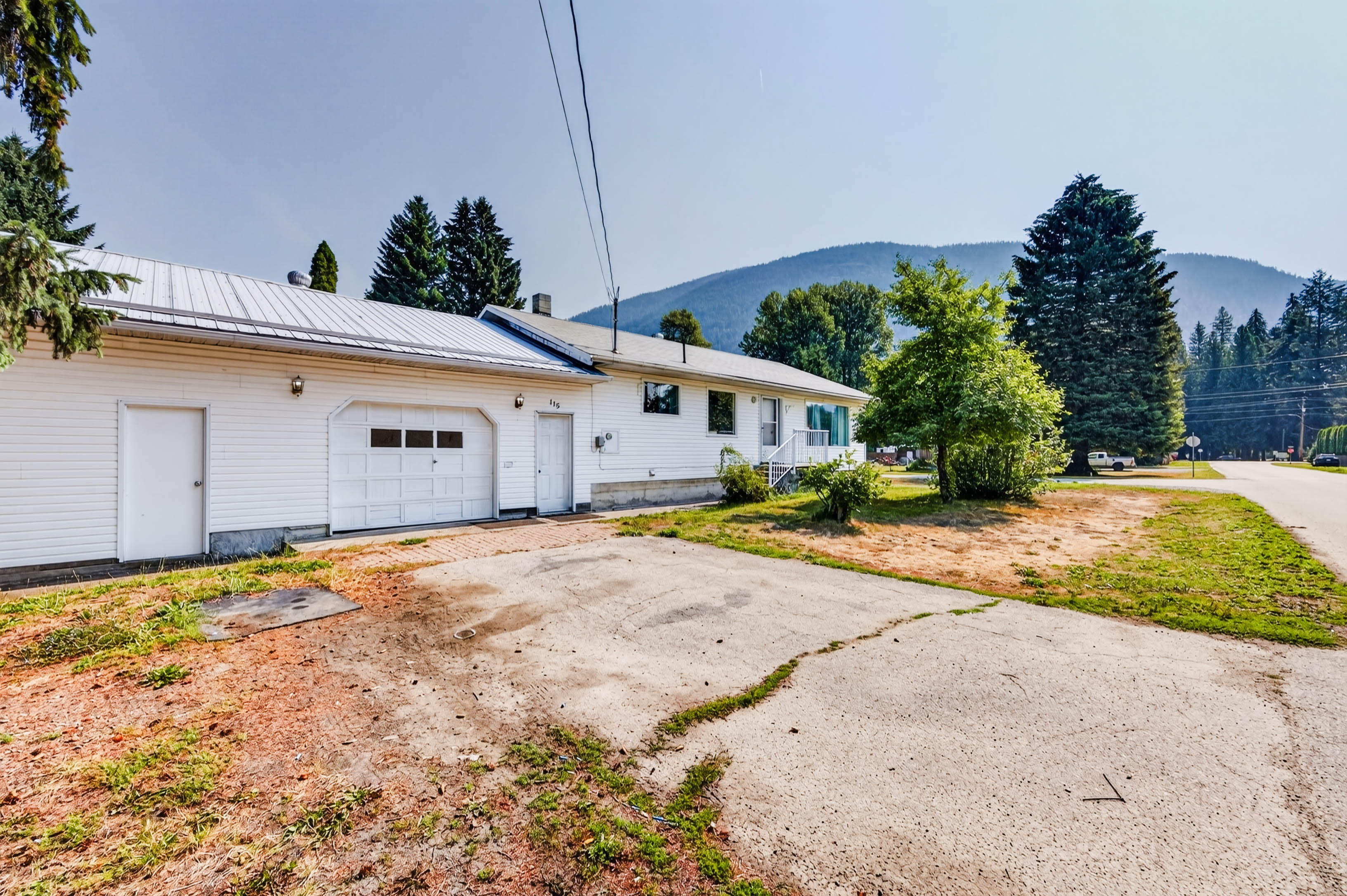 Front exterior and attached garage at 115 Second Street with mountains beyond